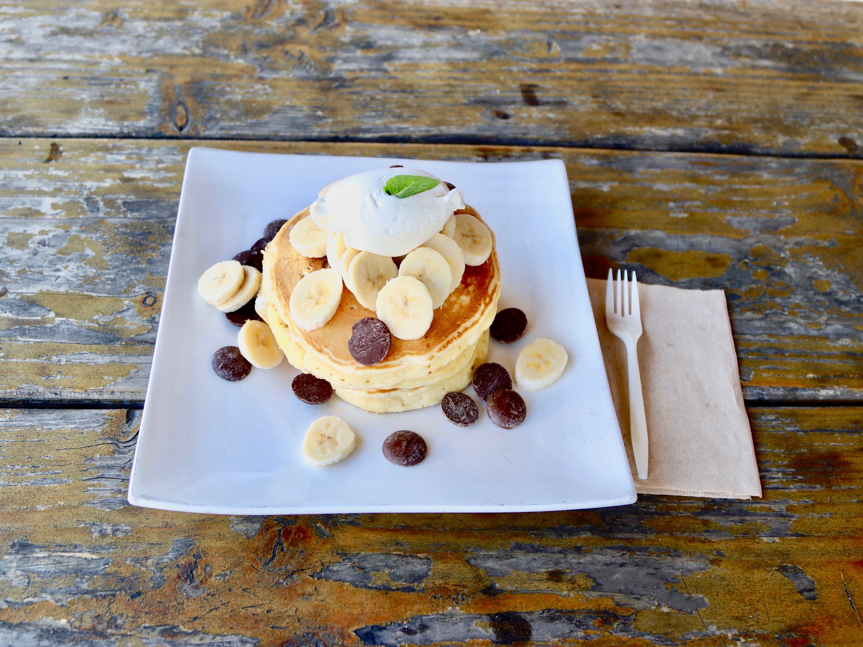 Order Guittard Chocolate Chip and Banana Pancakes food online from JiST Cafe store,  Los Angeles on bringmethat.com