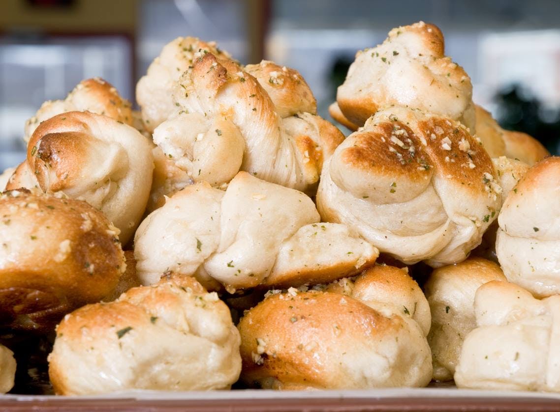 Order Garlic Knots with Sauce - 6 Pieces food online from Badabing Pizzeria store, Middletown on bringmethat.com