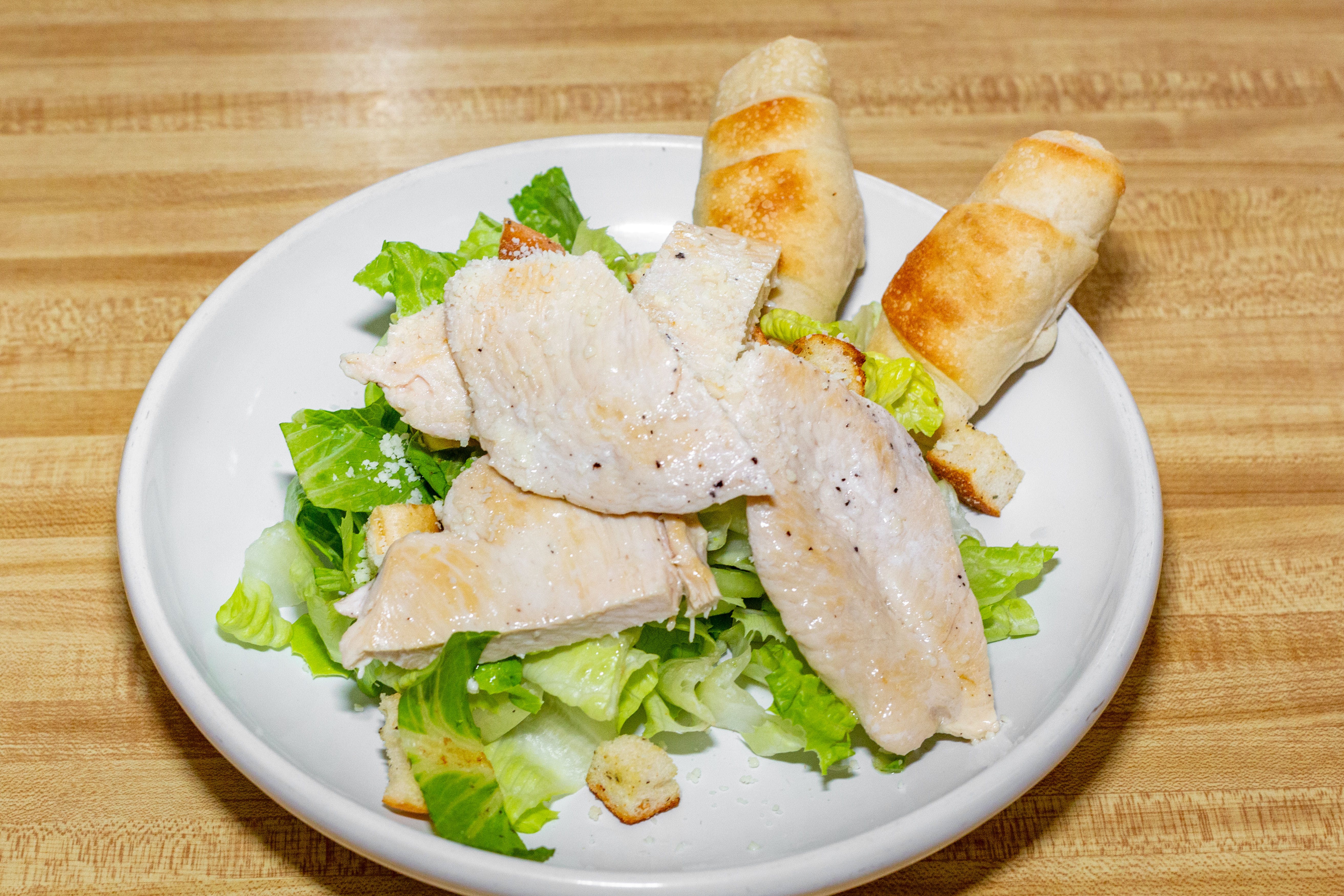 Order Chicken Caesar Salad - Salad food online from Capri Pizza store, Sicklerville on bringmethat.com