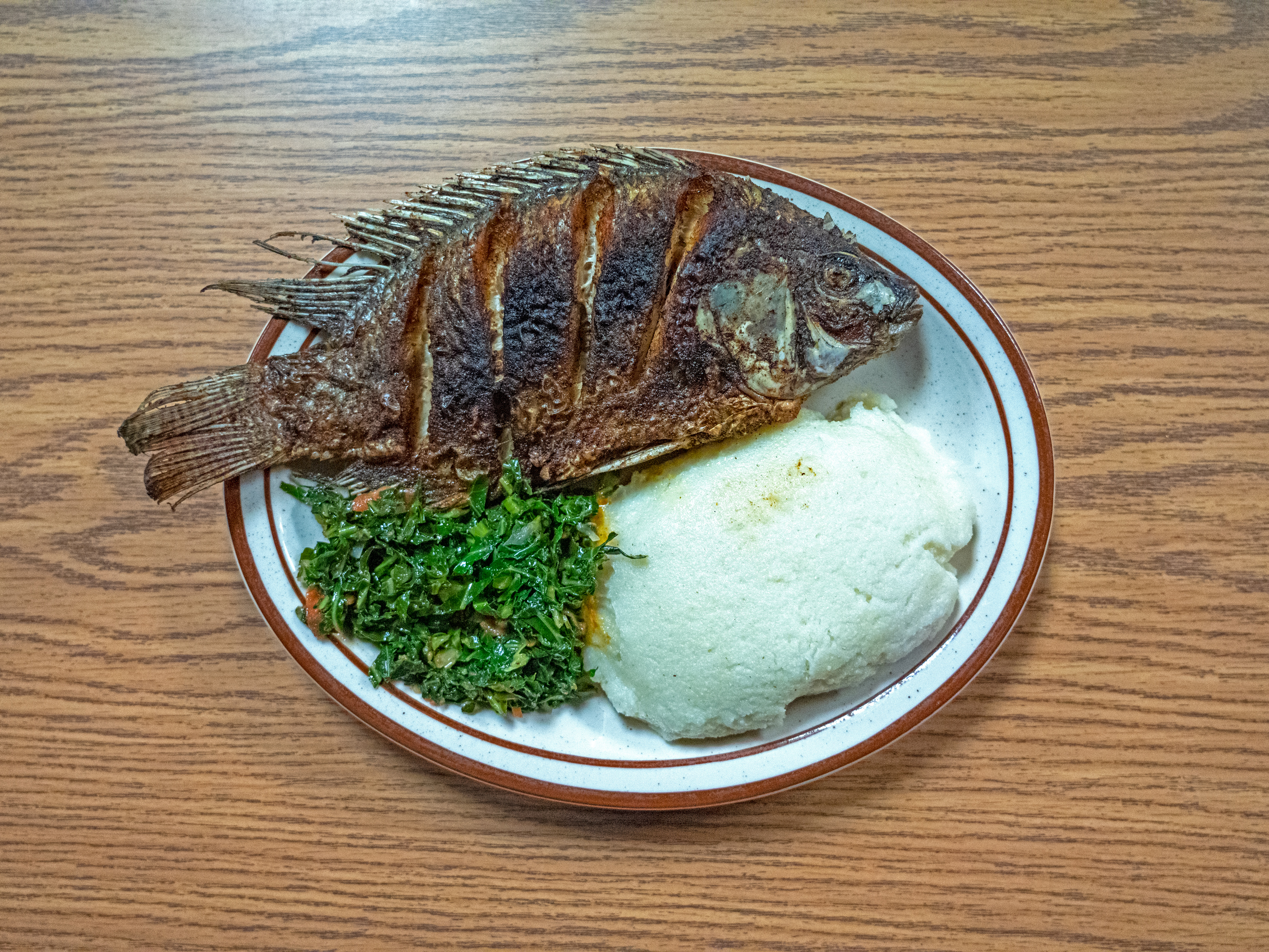 Order Nsima and Full Tilapia food online from International Fuse Bar & Grill store, South Bend on bringmethat.com