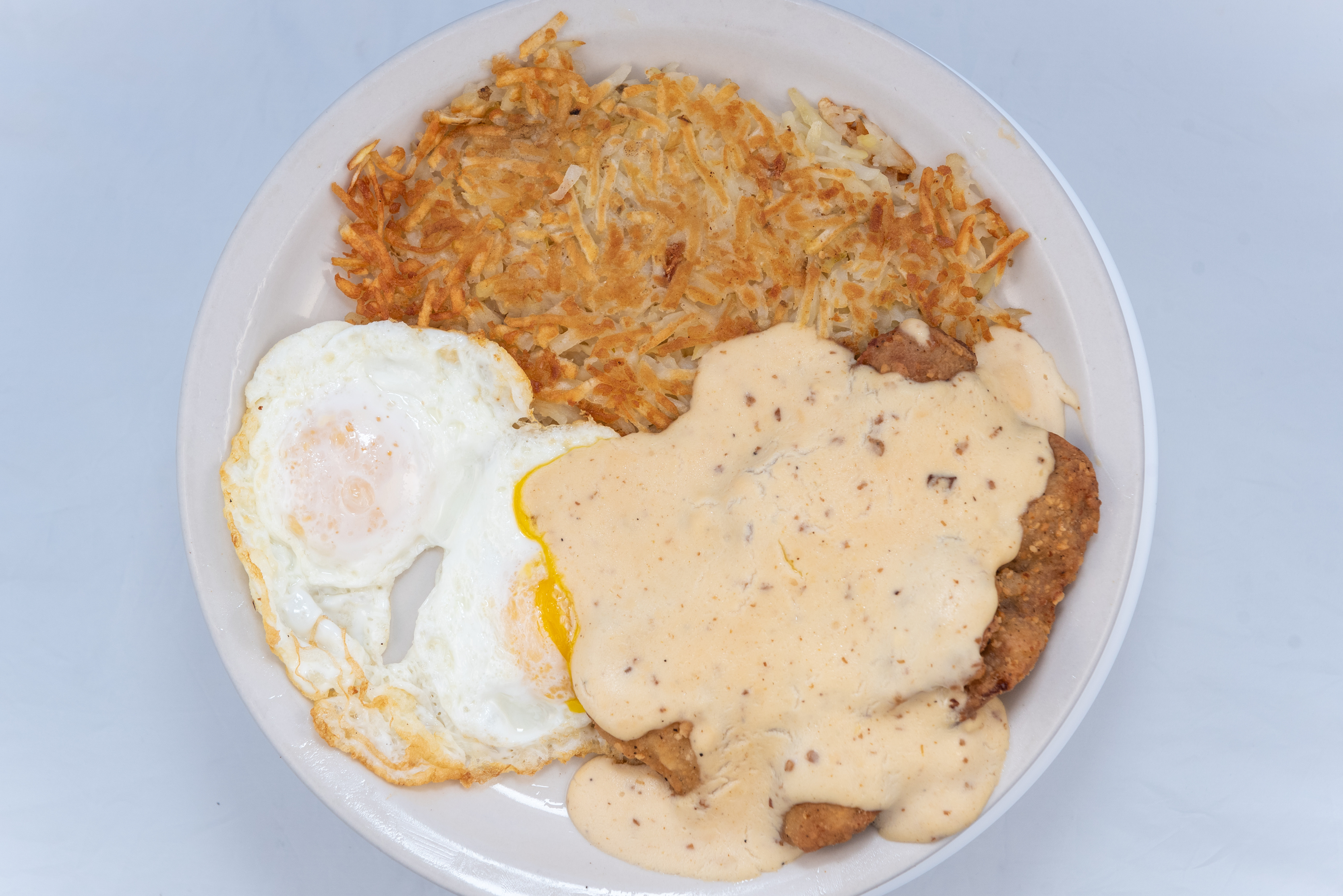 Order Chicken Fried Steak with sausage gravy, eggs and hash browns food online from The Cove On Castro store, San Francisco on bringmethat.com