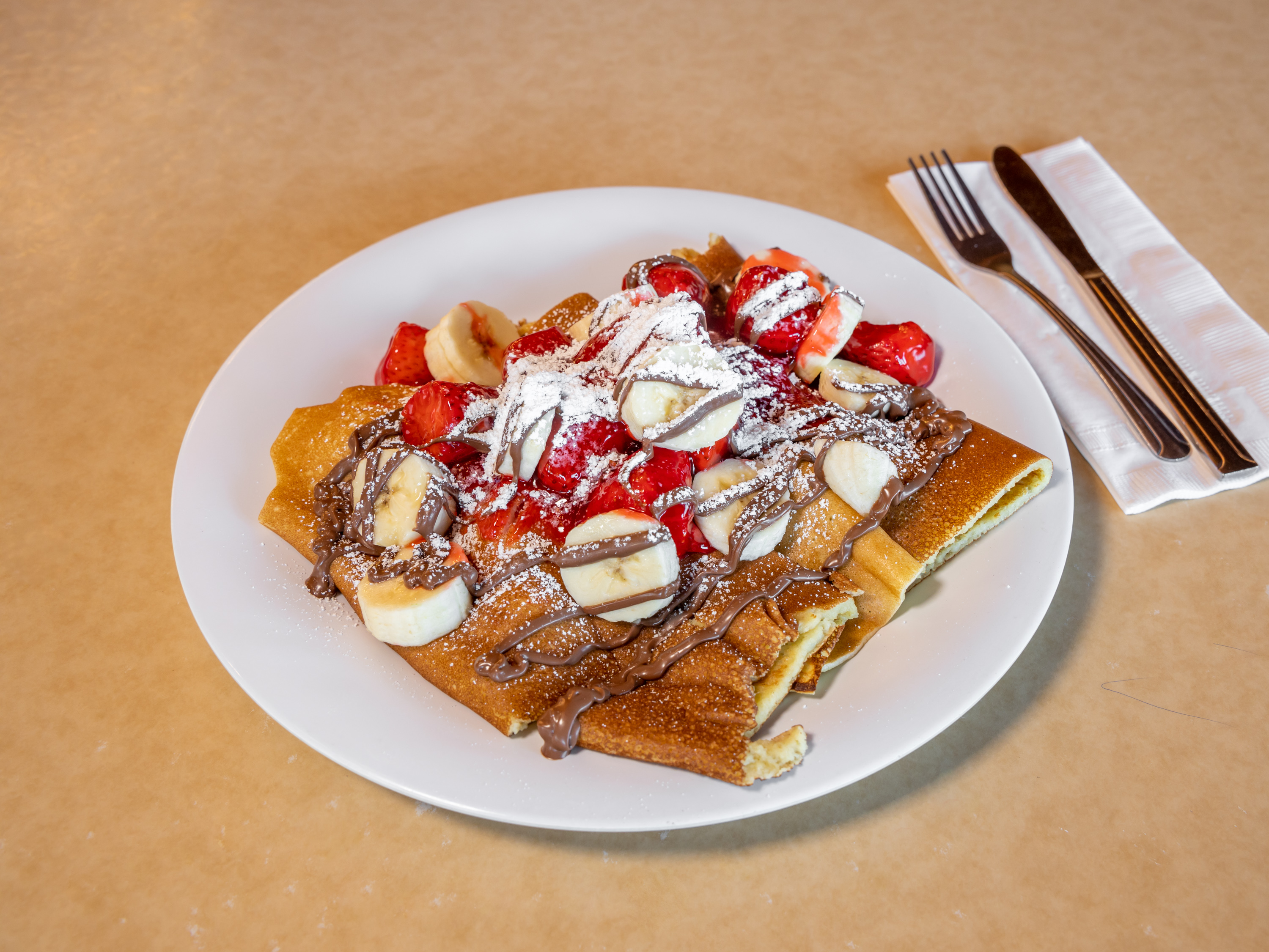Order Strawberry Nutella Banana Crepes food online from Sloan Restaurant store, Indio on bringmethat.com