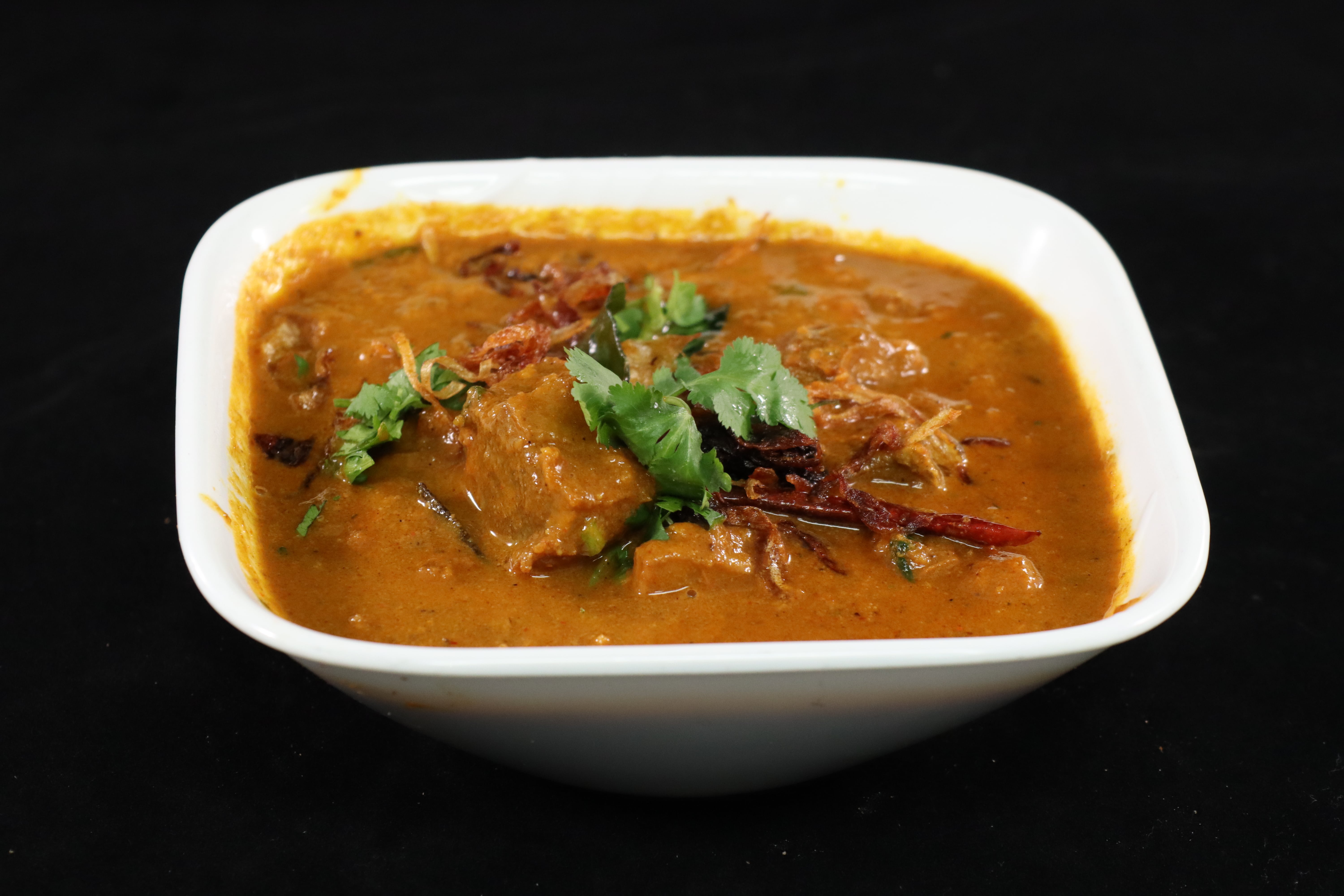 Order Goat Curry food online from Biryani Hub store, Norfolk on bringmethat.com