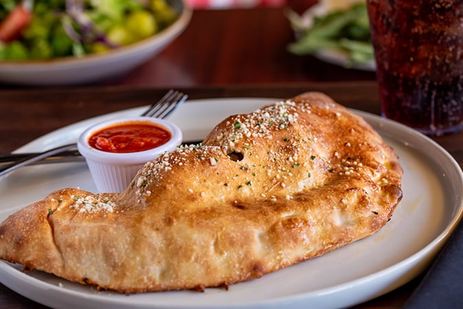 Order Doppio Pepperoni Calzone food online from Russo's Pizza store, Galveston on bringmethat.com