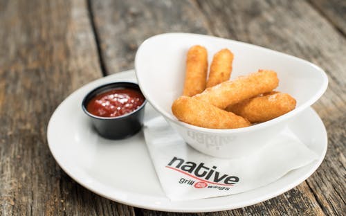 Order Mozzarella Cheese Sticks - Appetizer food online from Native Grill & Wings store, Phoenix on bringmethat.com