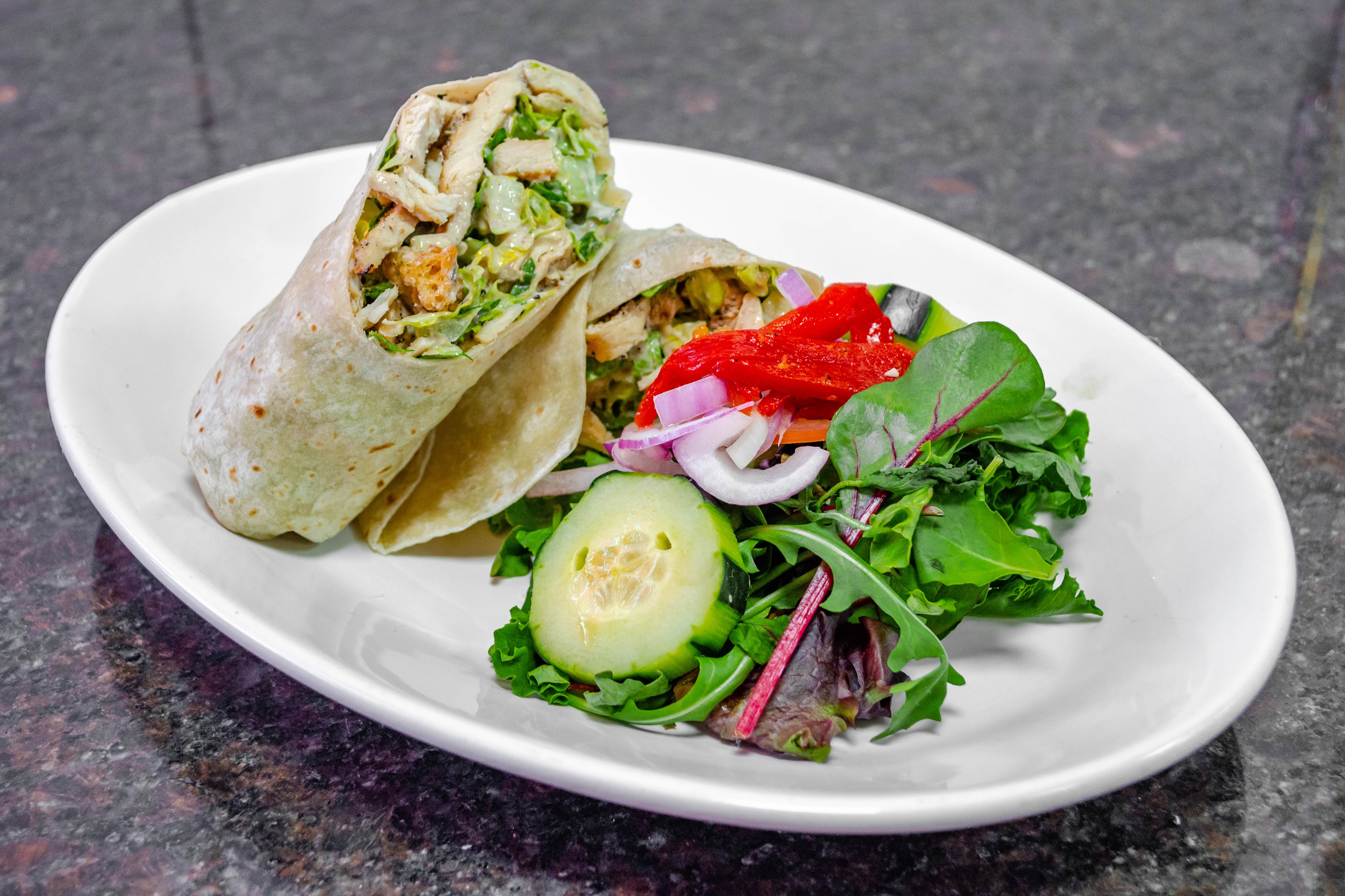 Order Grilled Chicken Caesar Wrap - Wrap food online from Justino's Pizza store, New York on bringmethat.com