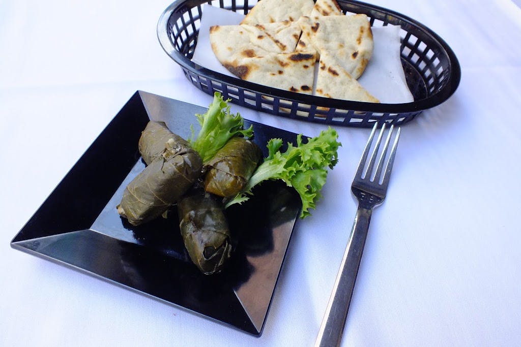 Order Stuffed Grape Leaves - 4 Pieces food online from Giovanni's Pizza store, Pittsburgh on bringmethat.com