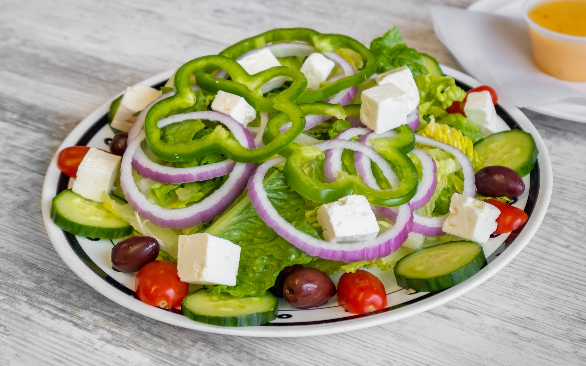 Order Greek Salad food online from Good Fellas Pizza store, Warrenton on bringmethat.com