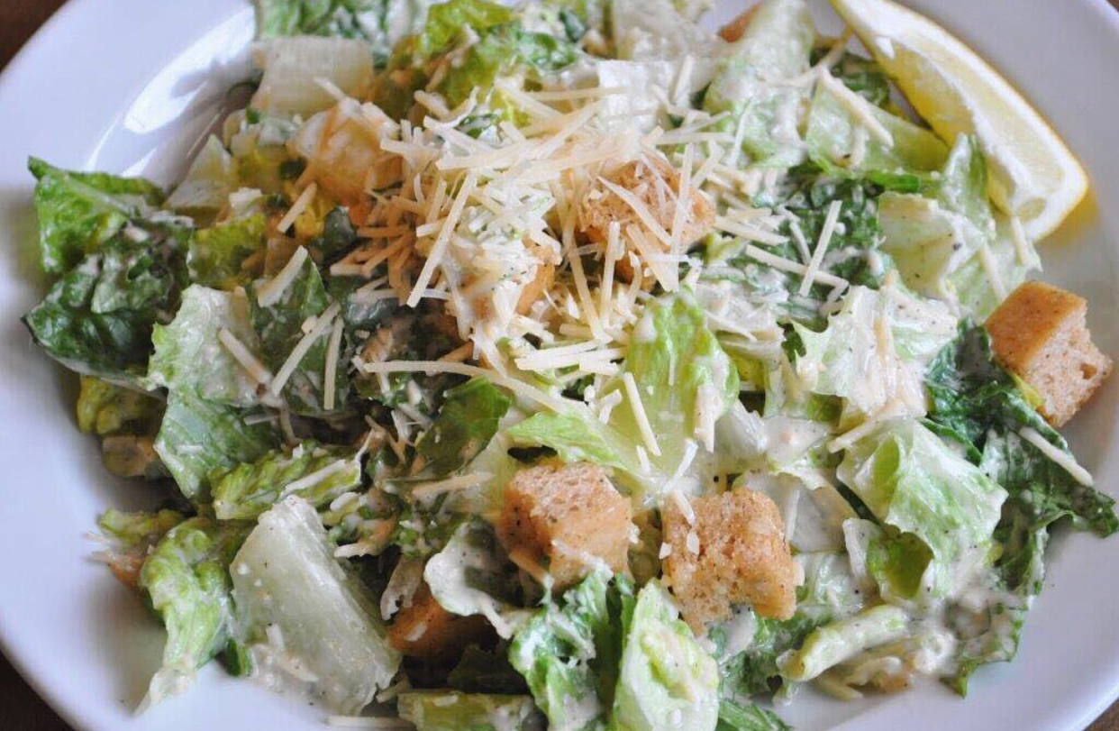 Order Caesar Salad (T) food online from Razzis Pizzeria store, Seattle on bringmethat.com