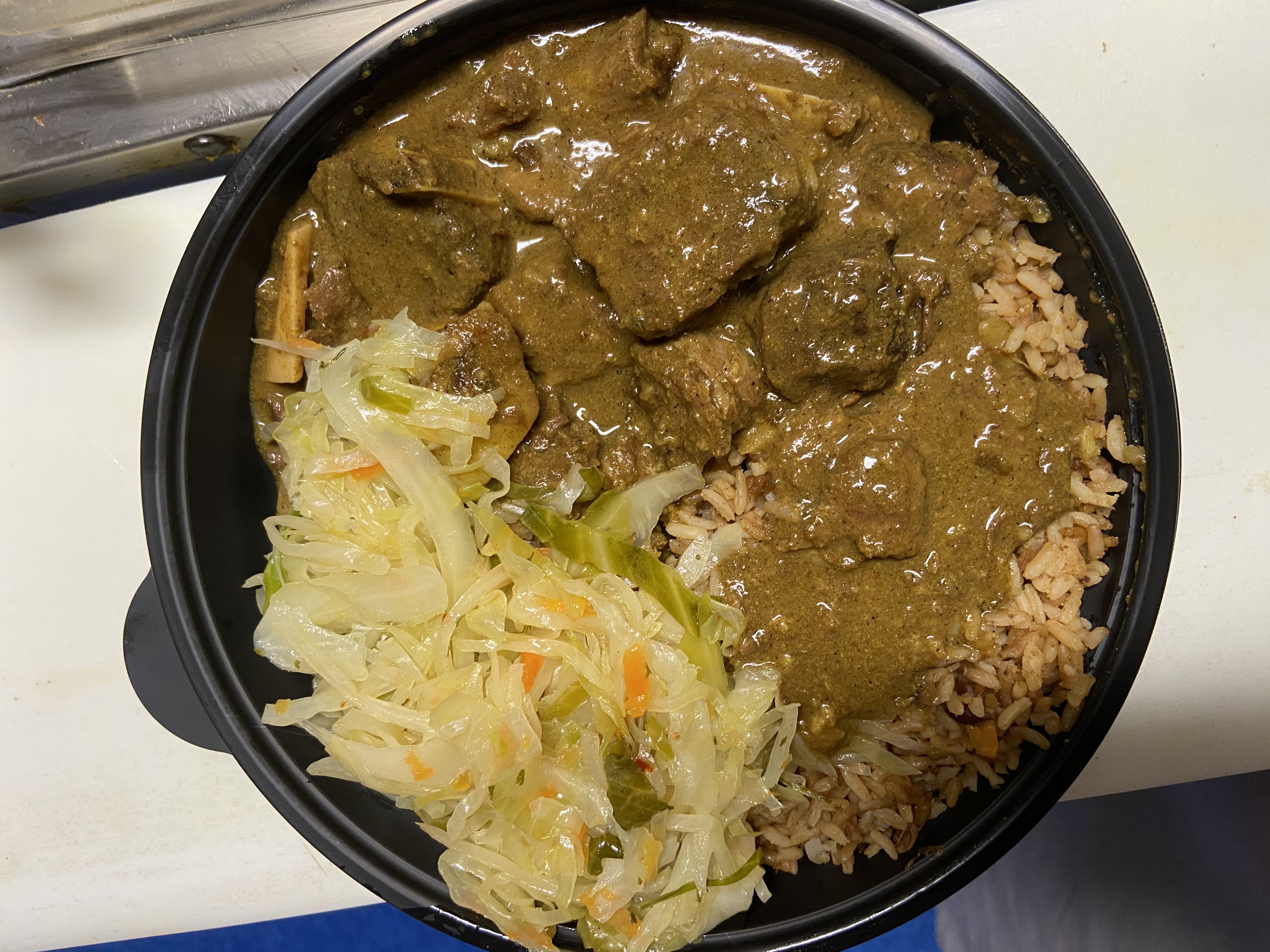 Order Curry Goat with Rice and Beans food online from Taste of the Caribbean store, Capitol Heights on bringmethat.com