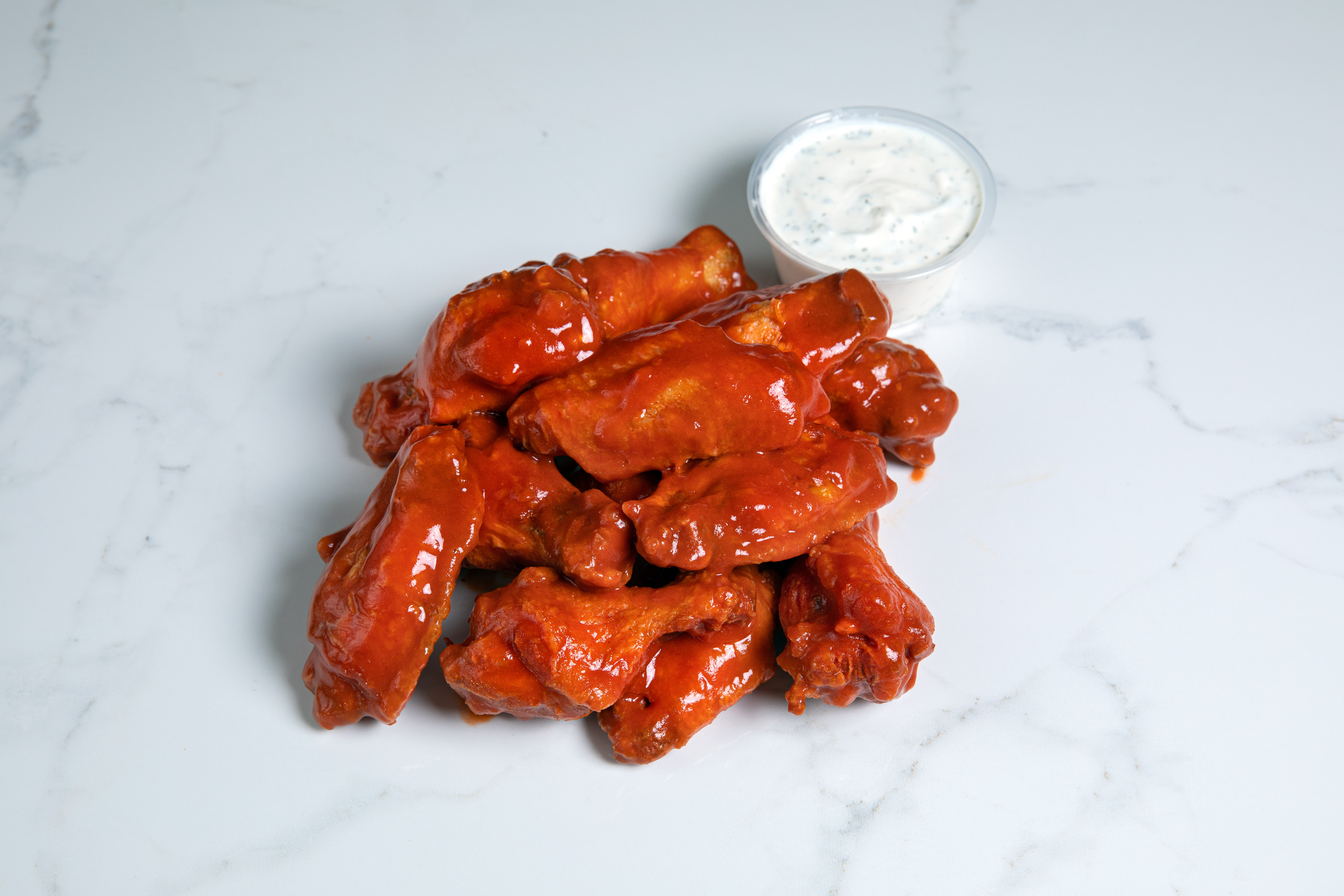 Order Wingin Clucker • 12pc food online from Cluckin Bun store, cathedral city on bringmethat.com