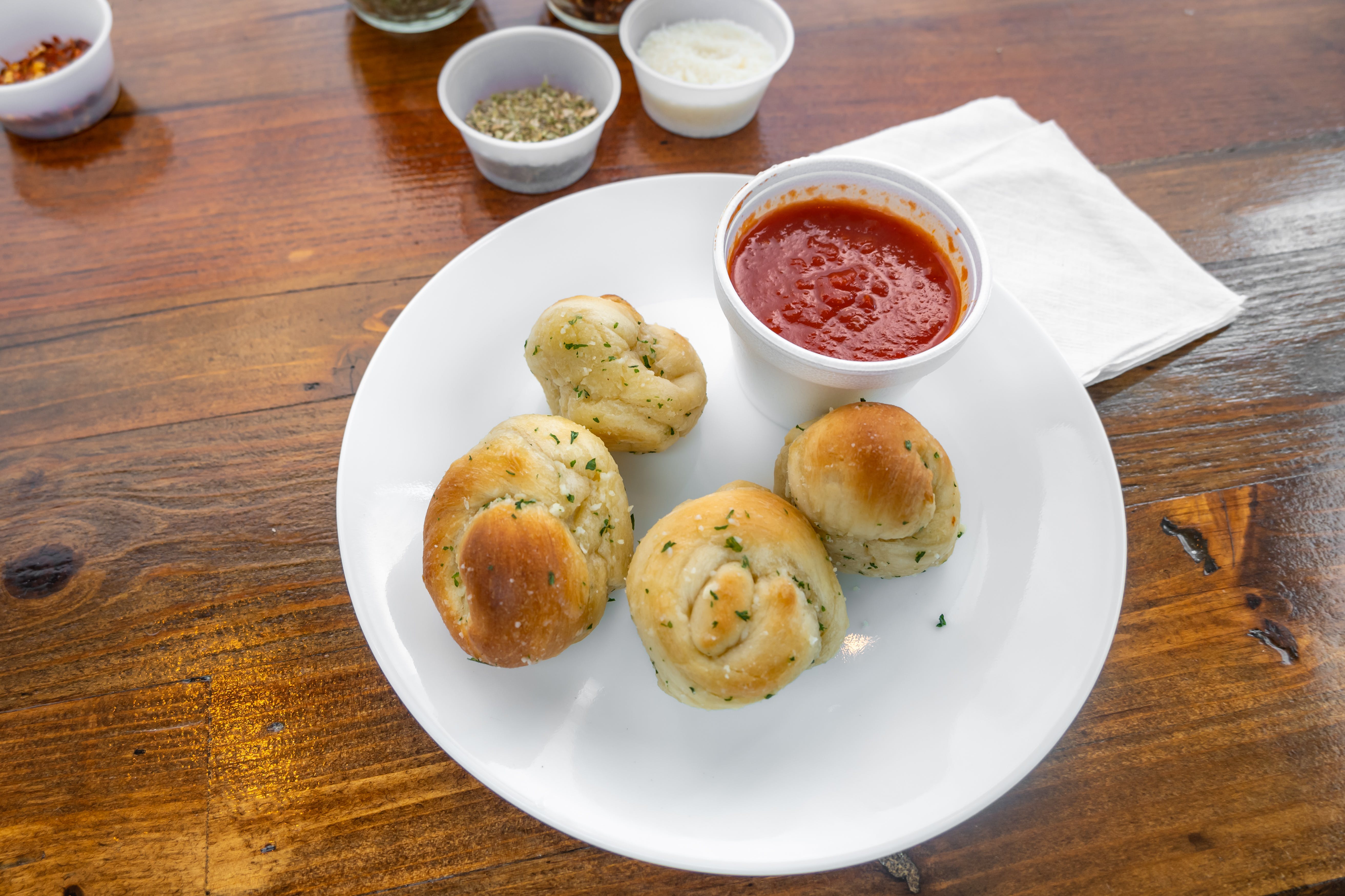 Order Garlic Knots - 4 Pieces food online from Cosimos Pizza Cafe store, Philadelphia on bringmethat.com