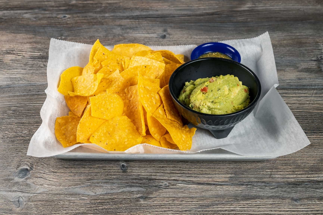 Order Guac (hand mashed) w/chips food online from High Tide Taco Bar store, Farmingdale on bringmethat.com