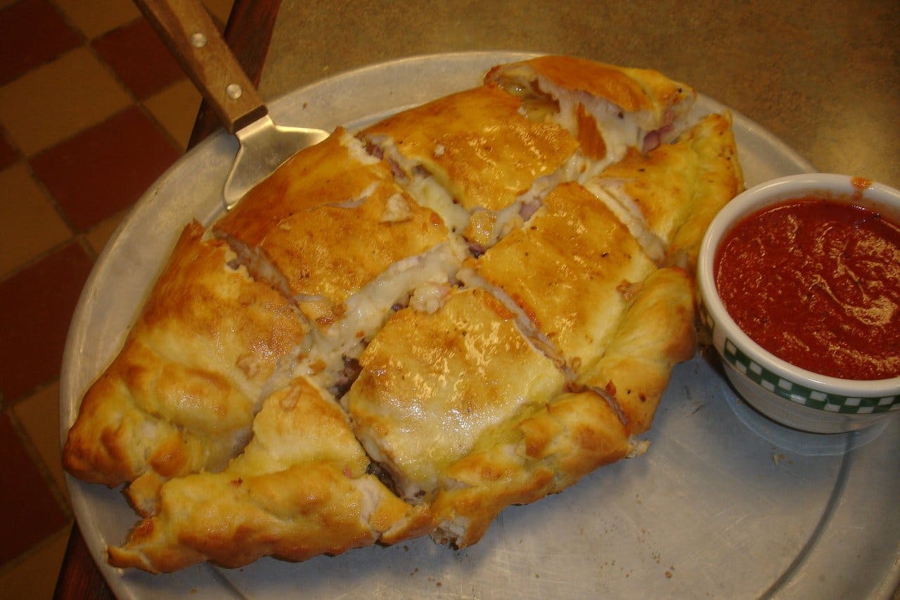 Order Calzone - Calzone food online from Pino's on Main Pizza store, Rockford on bringmethat.com