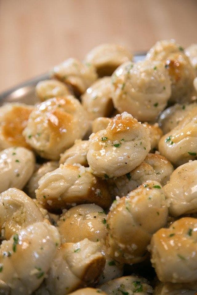 Order Garlic Knots - 1 Piece food online from Broadway Pizza & Catering store, Greenlawn on bringmethat.com