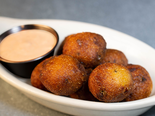 Order Jalapeno Hush Puppies food online from Rockfish Seafood Grill store, McKinney on bringmethat.com