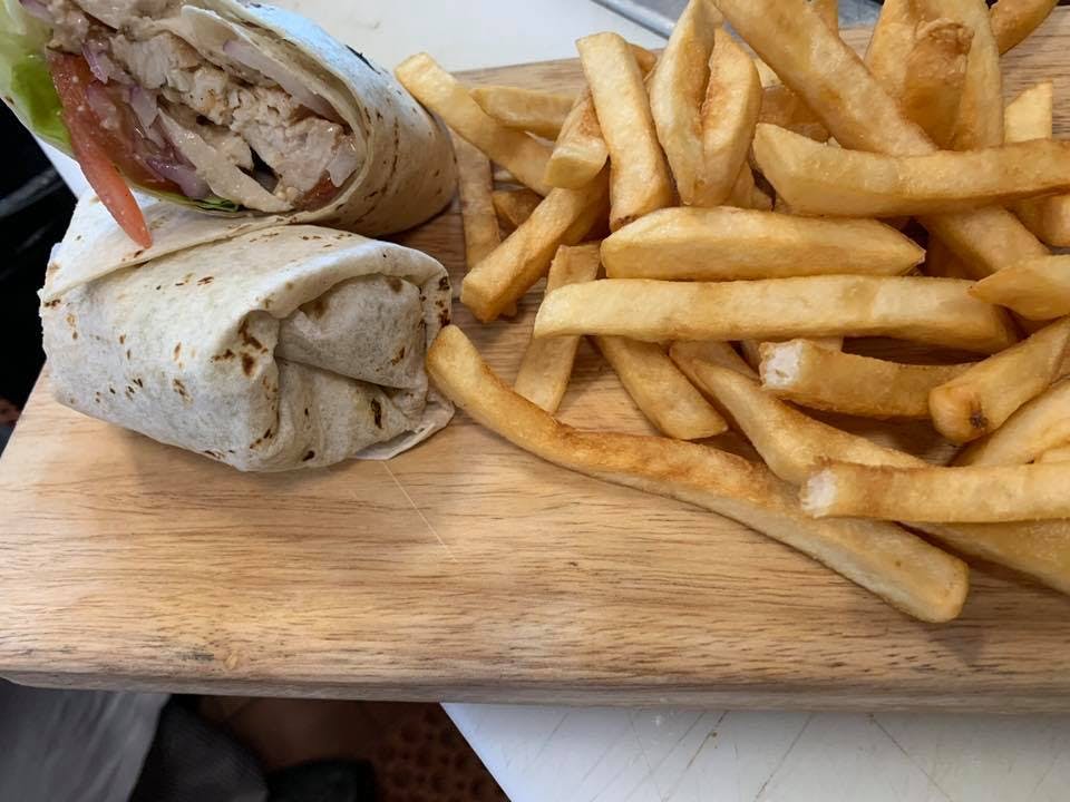 Order Grilled Chicken Caesar Wrap - Wrap food online from Trattoria Di Napoli Restaurant store, Bear on bringmethat.com