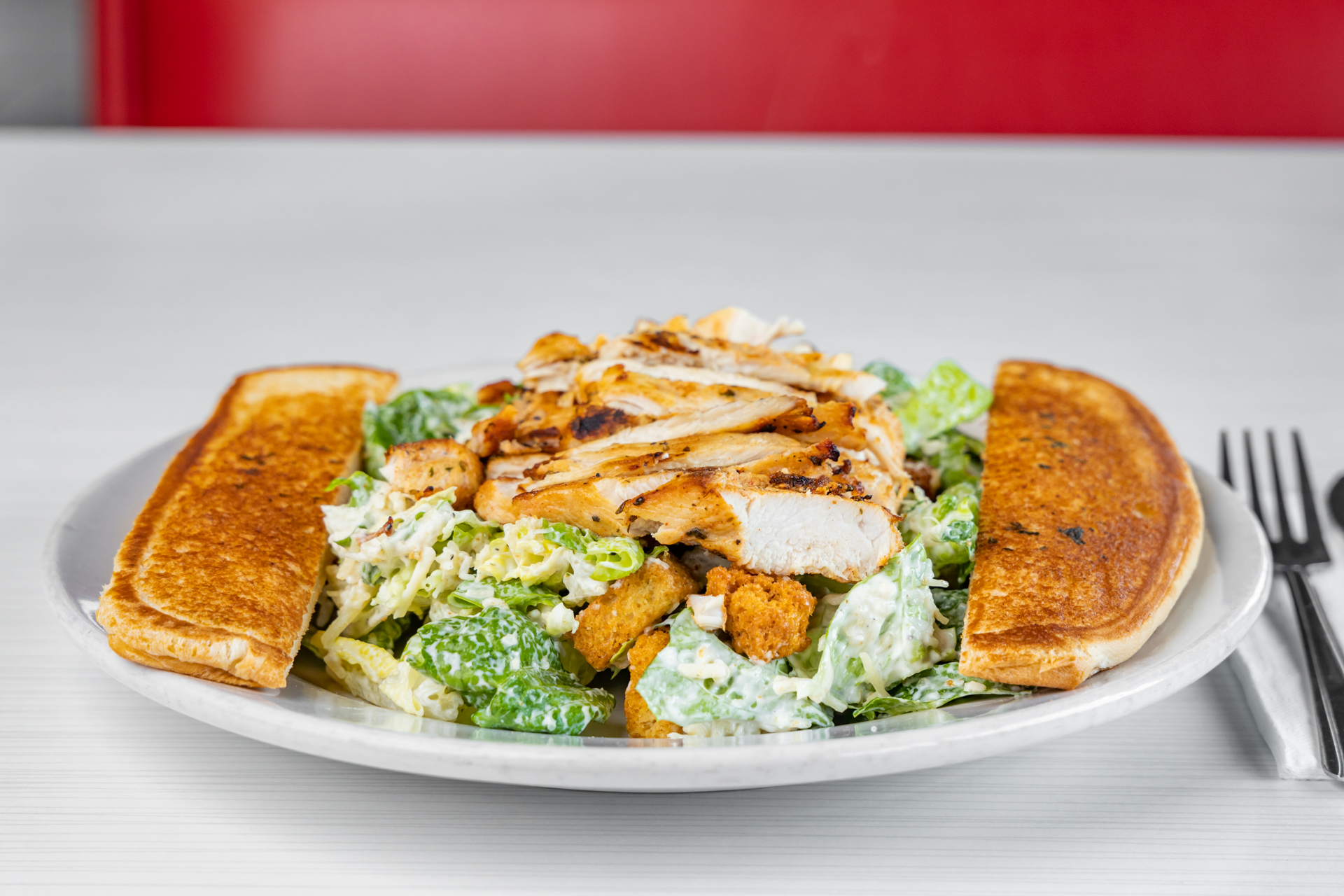 Order Chicken Caesar Salad  food online from Goody Cafe store, Palm Desert on bringmethat.com