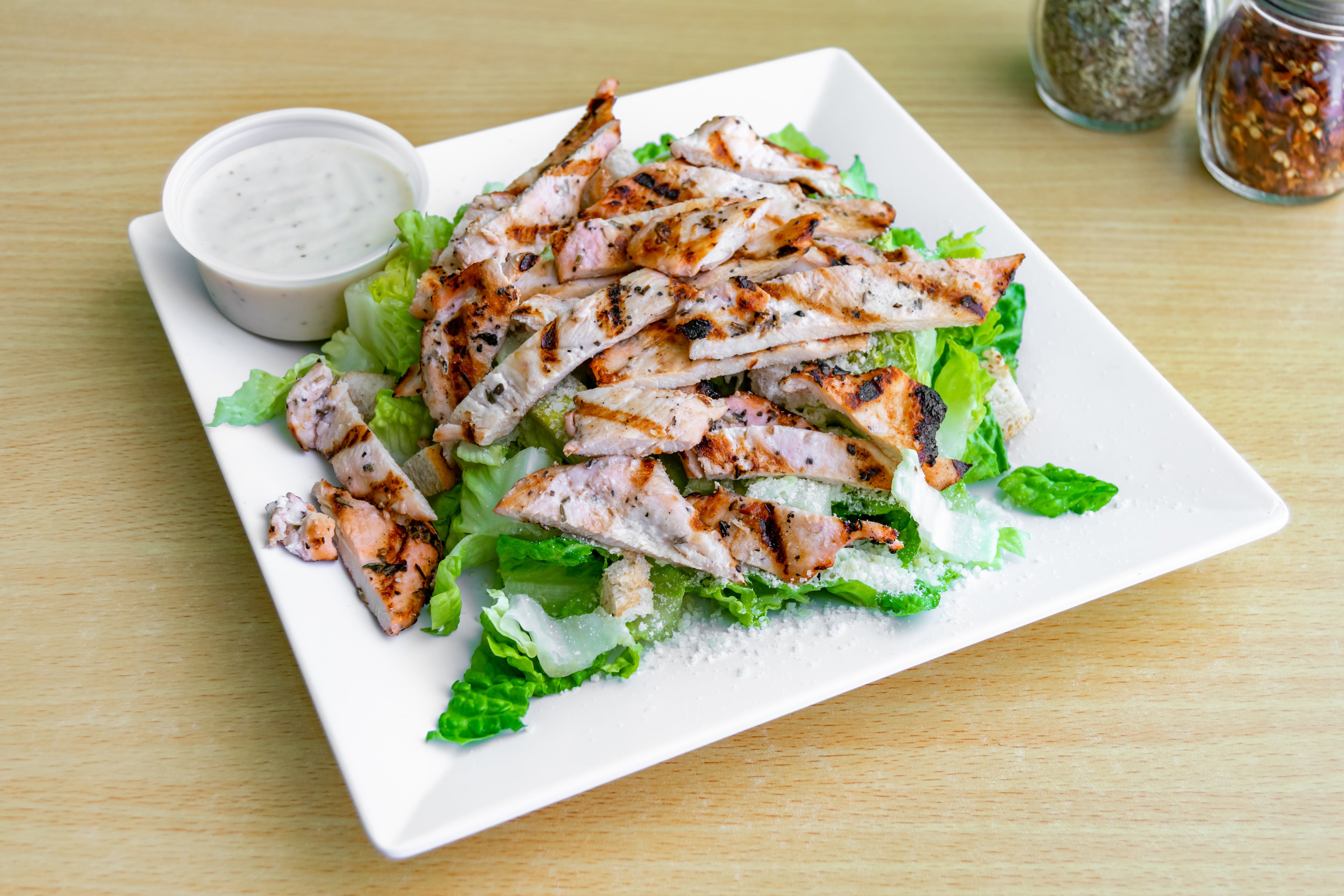 Order Grilled Chicken Caesar Salad - Salad food online from Dolce Pizza store, East Orange on bringmethat.com