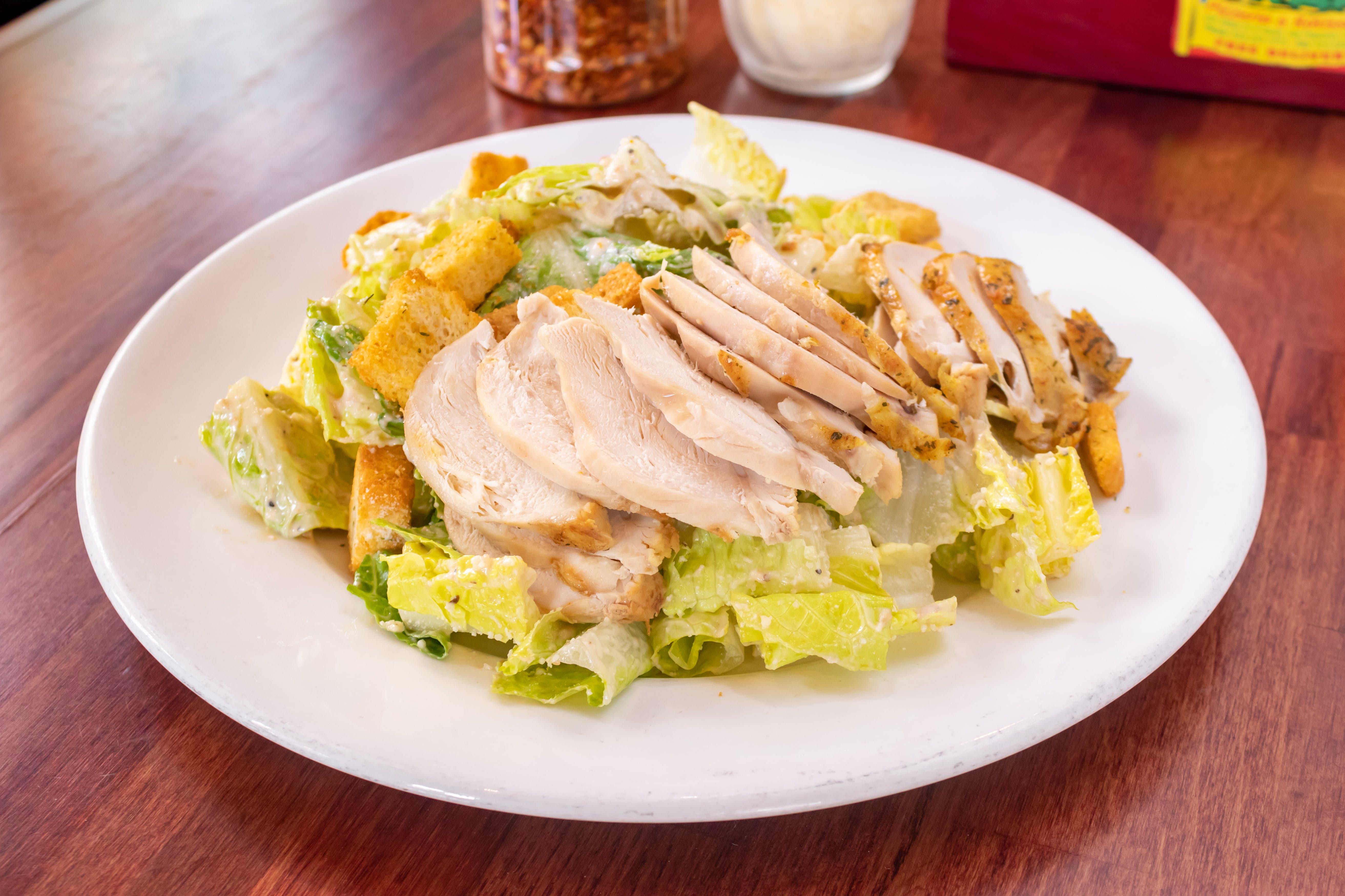 Order Caesar Salad with Herb Roasted Chicken - Salad food online from Piraat Pizzeria store, San Francisco on bringmethat.com