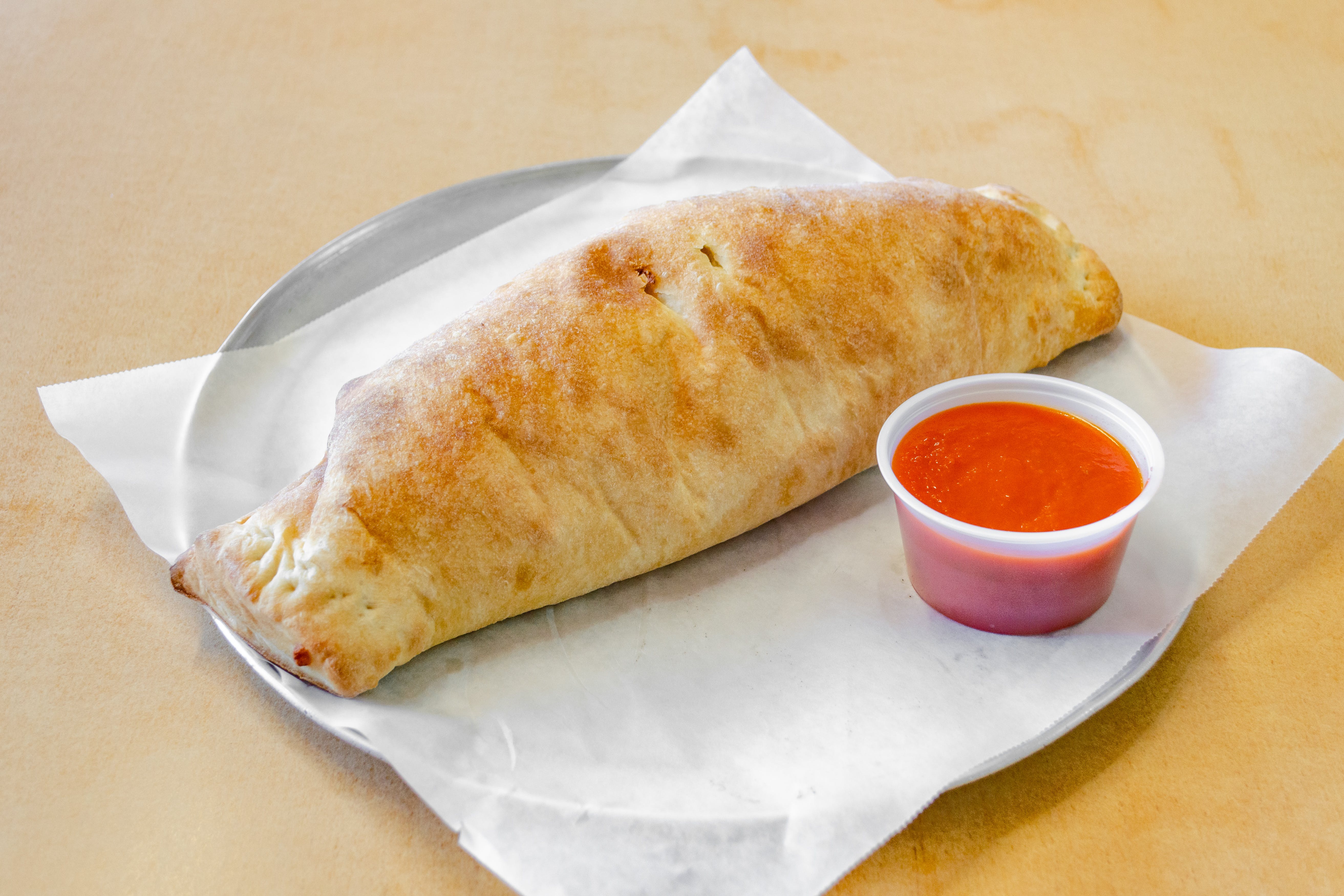 Order Sausage, Peppers & Onions Stromboli - Small food online from Ranchito Pizzeria & Mexican Restaurant store, Fords on bringmethat.com