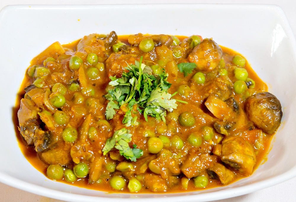 Order Mushroom Green Peas Masala food online from Rajput Indian Cuisine store, Suffolk on bringmethat.com