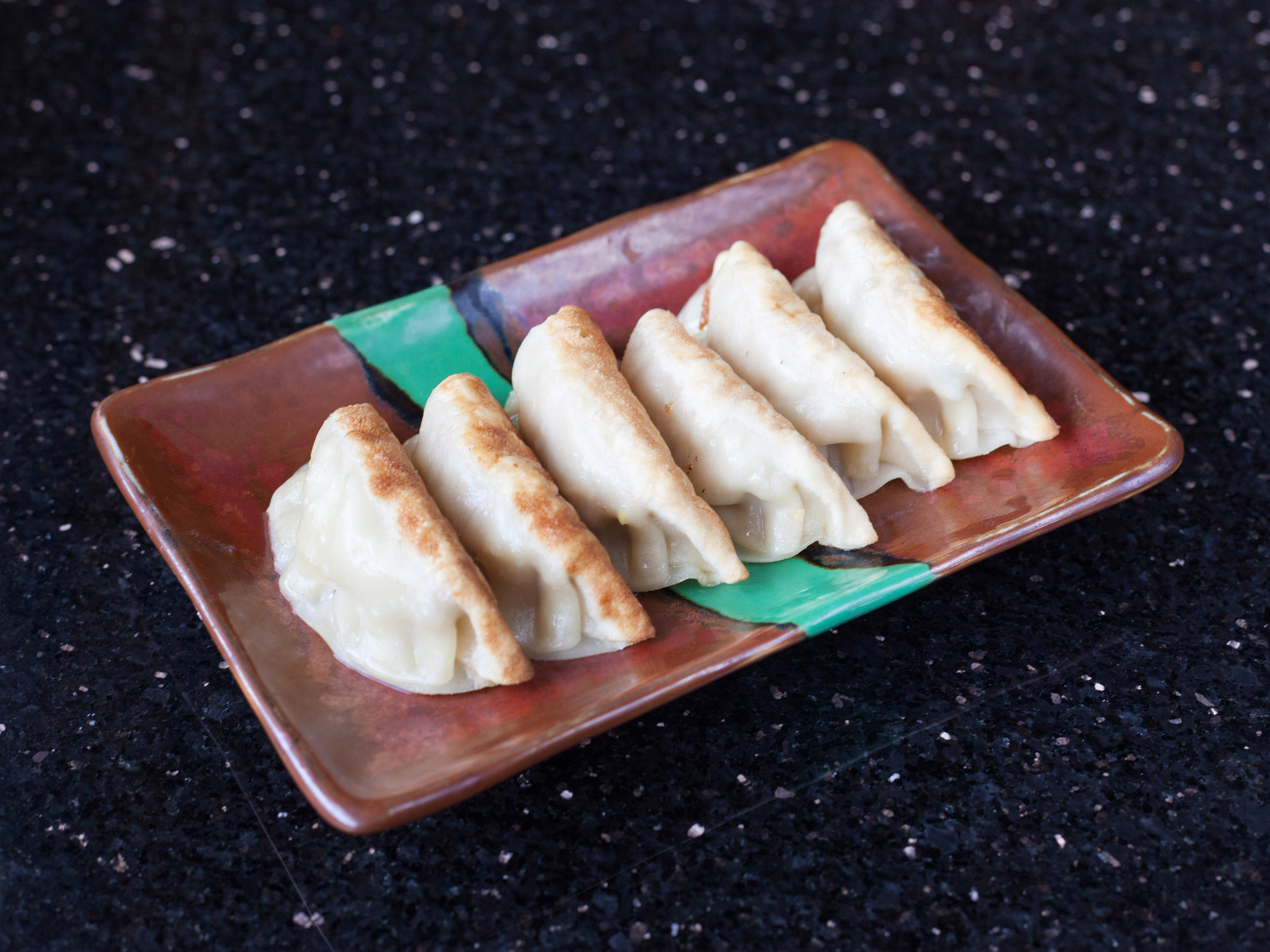 Order Pan-Fried Dumplings food online from Asian Pearl Restaurant store, Olathe on bringmethat.com