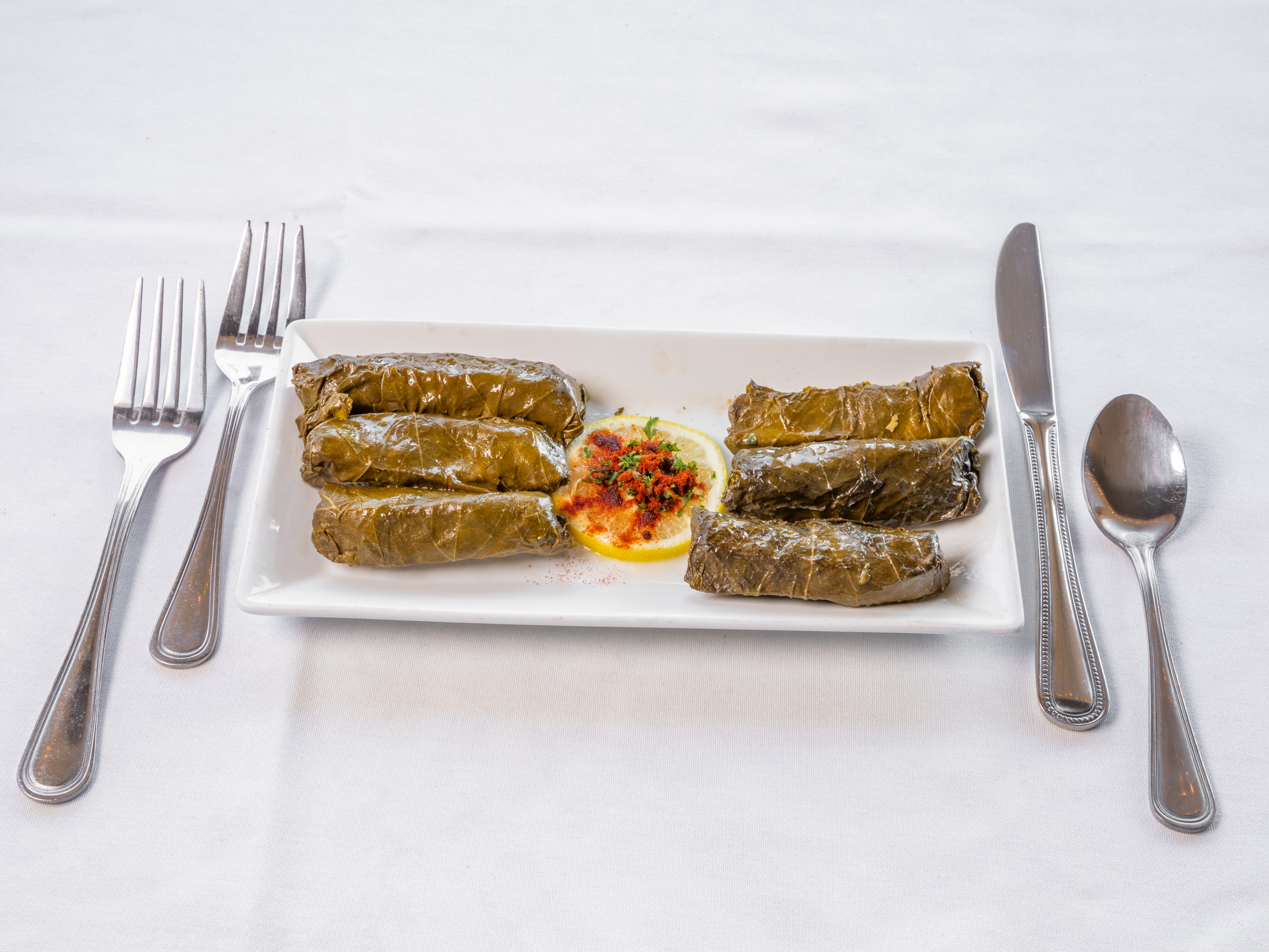 Order Veggie Stuffed Grape Leaves food online from Famous Steakhouse store, Tulsa on bringmethat.com