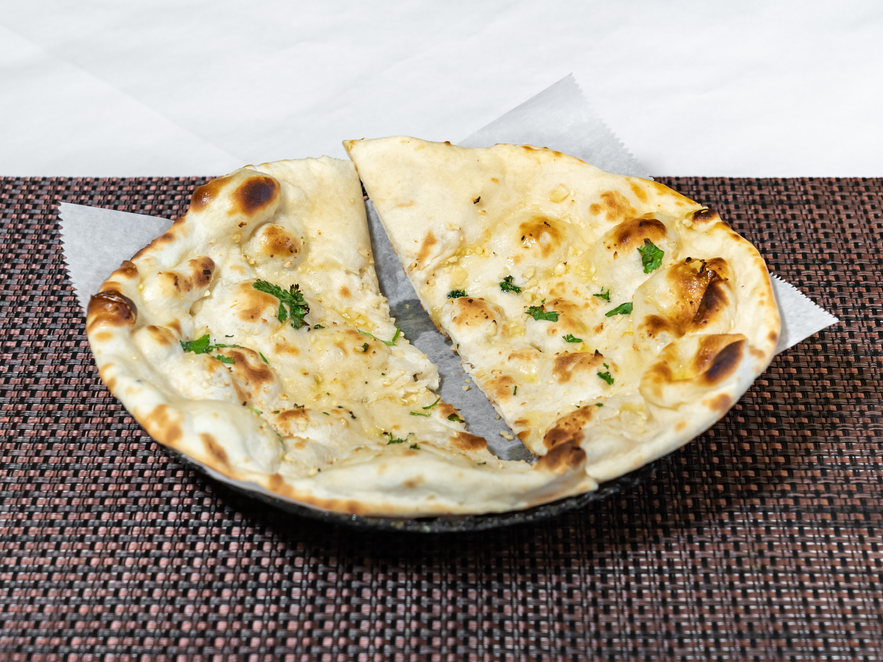 Order 94. Garlic Naan food online from New Little India store, Shelby Township on bringmethat.com