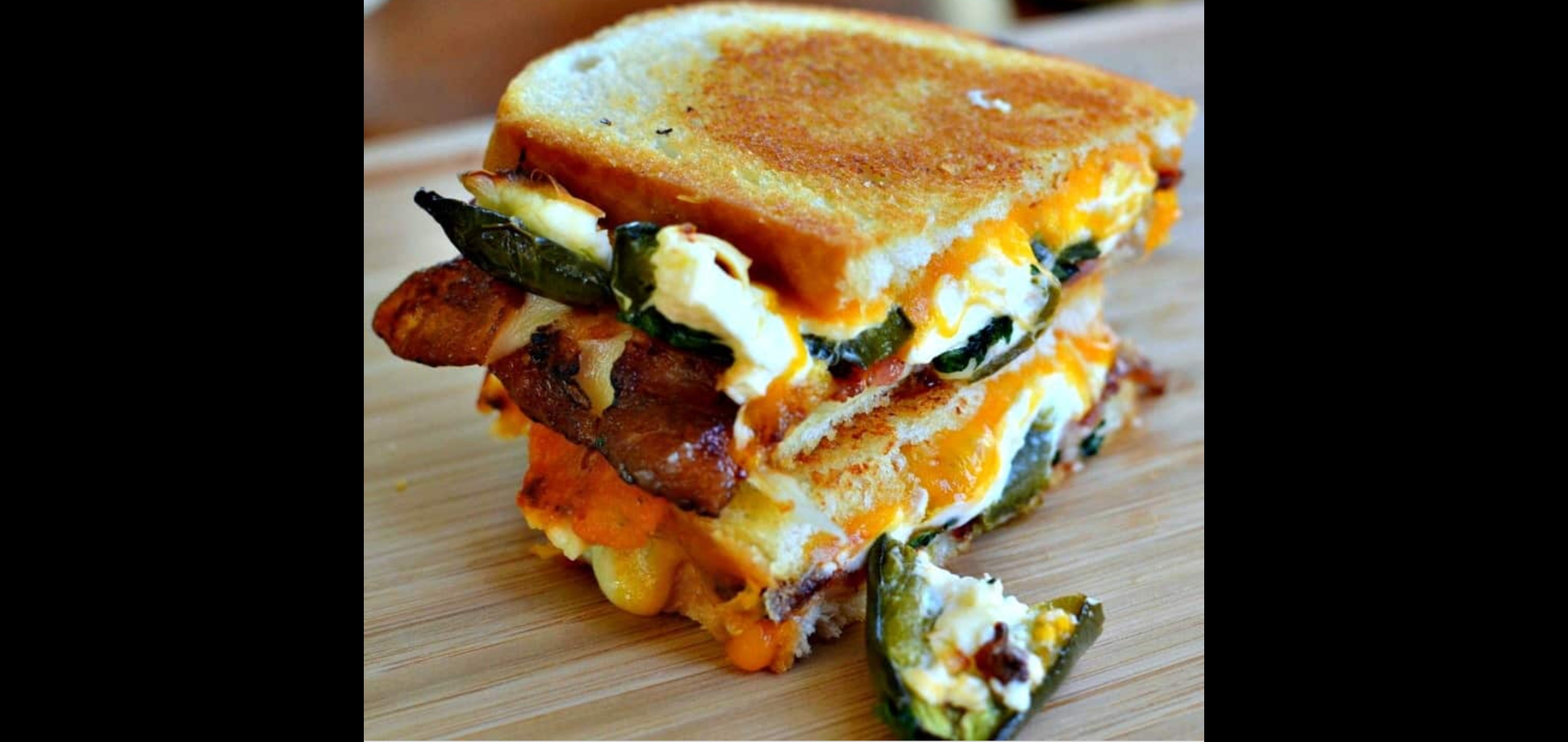 Order  Spicy Grilled Cheese With Bacon Cheddar & Pepper  Jack with Jalapeños & Sriracha Hot Sauce)  food online from American Gourmet Foods Deli store, New York on bringmethat.com