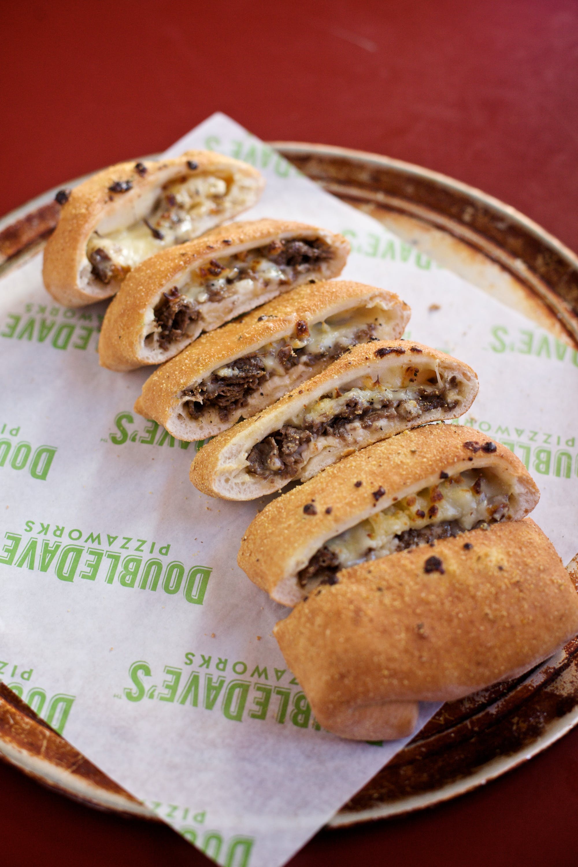 Order Philly Cheesesteak Stromboli - Medium food online from DoubleDave's Pizzaworks store, Houston on bringmethat.com