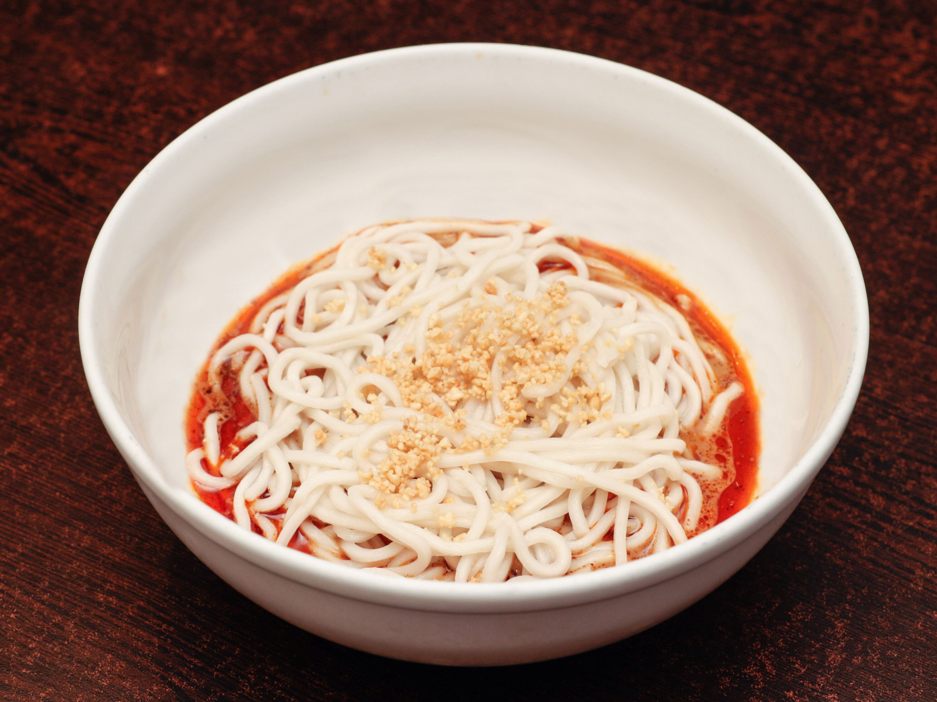 Order Noodles in Spicy Sesame Sauce, Topped with Crushed Peanuts 擔擔麵 food online from A&J Bistro 半畝園 store, East Hanover on bringmethat.com