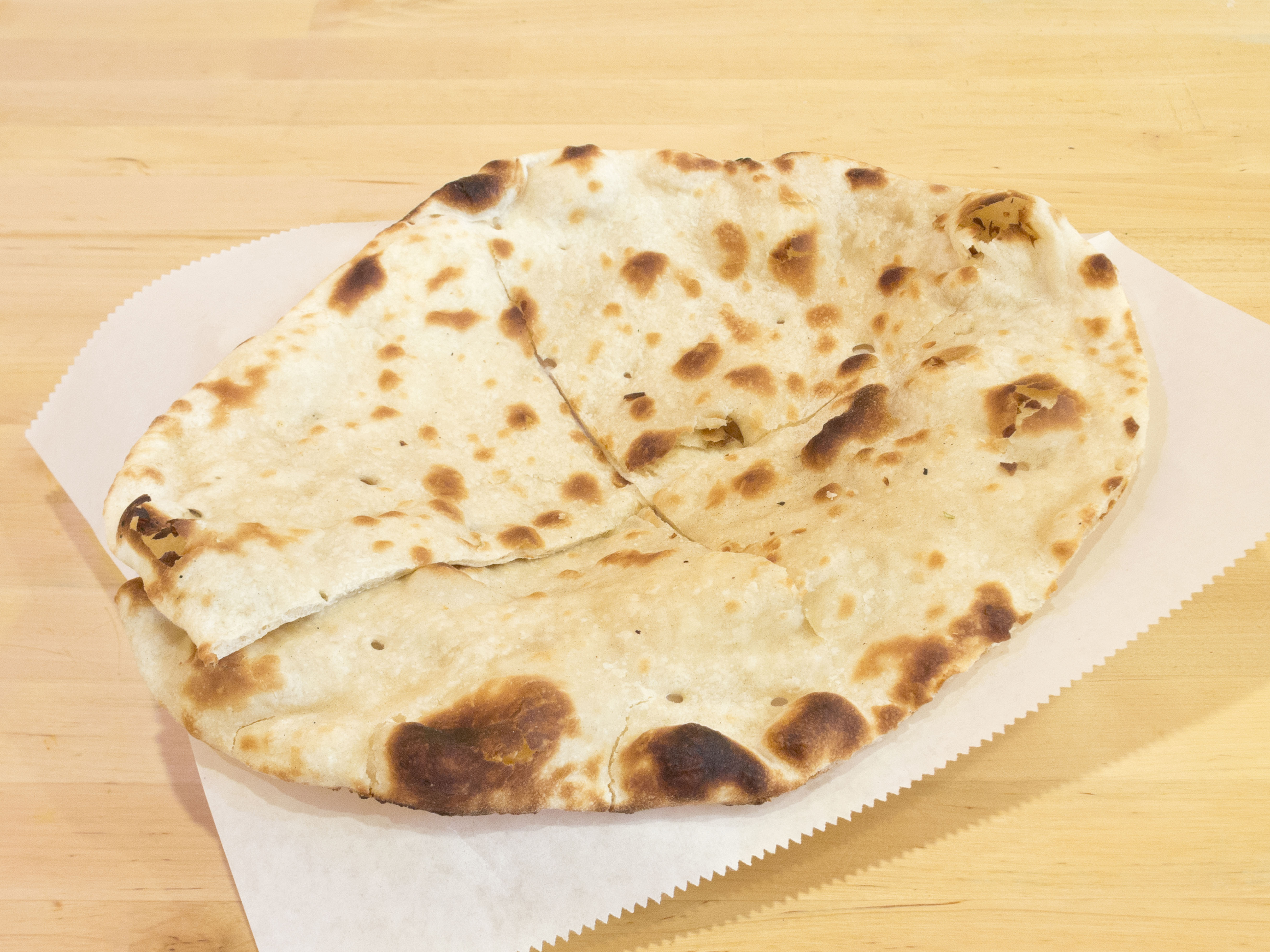Order E1. Plain Naan food online from Mela Indian Cuisine store, Fort Worth on bringmethat.com