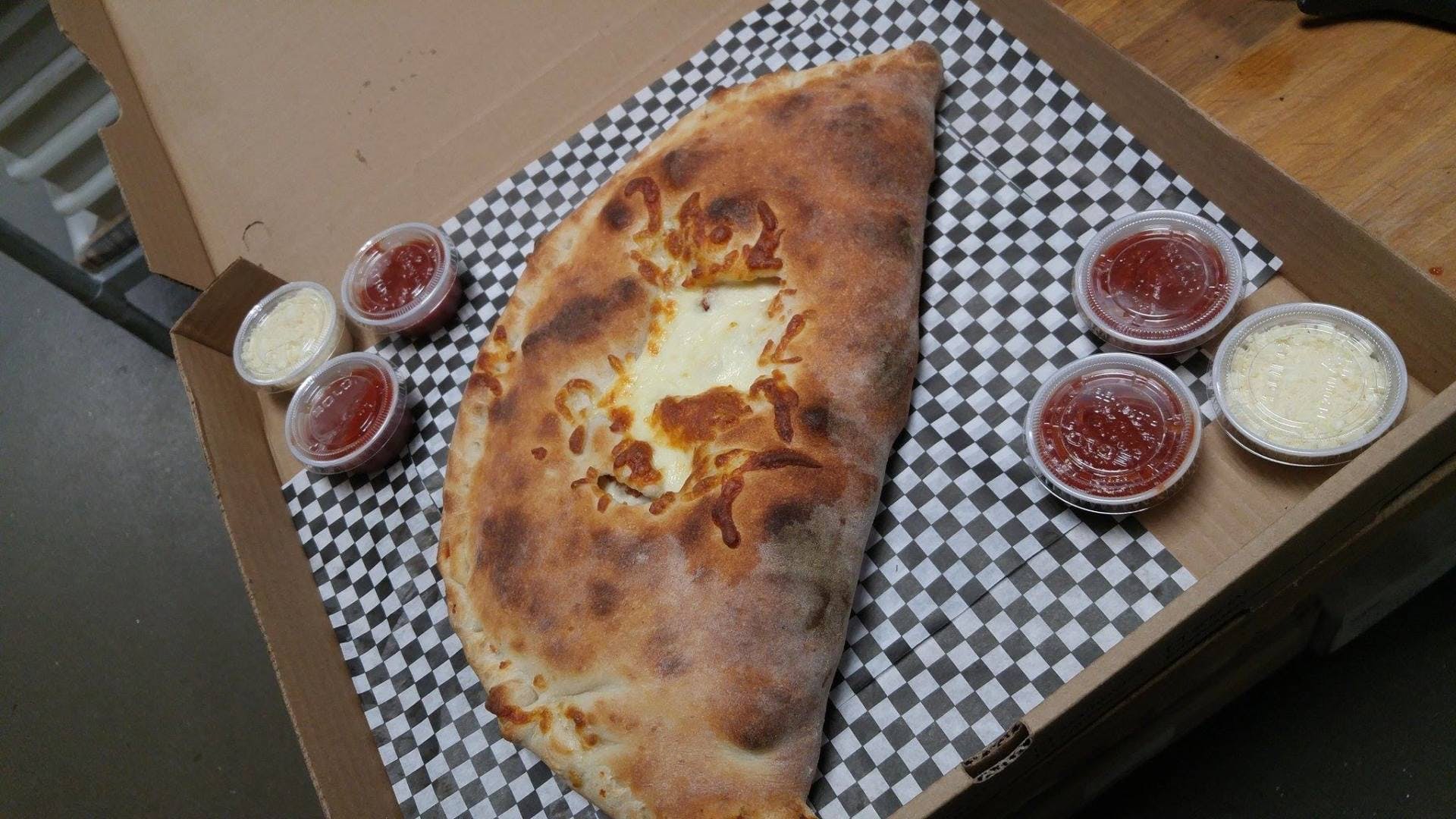 Order Chicken Parmesan Calzone - Small food online from Rustic Pizza store, Sherborn on bringmethat.com