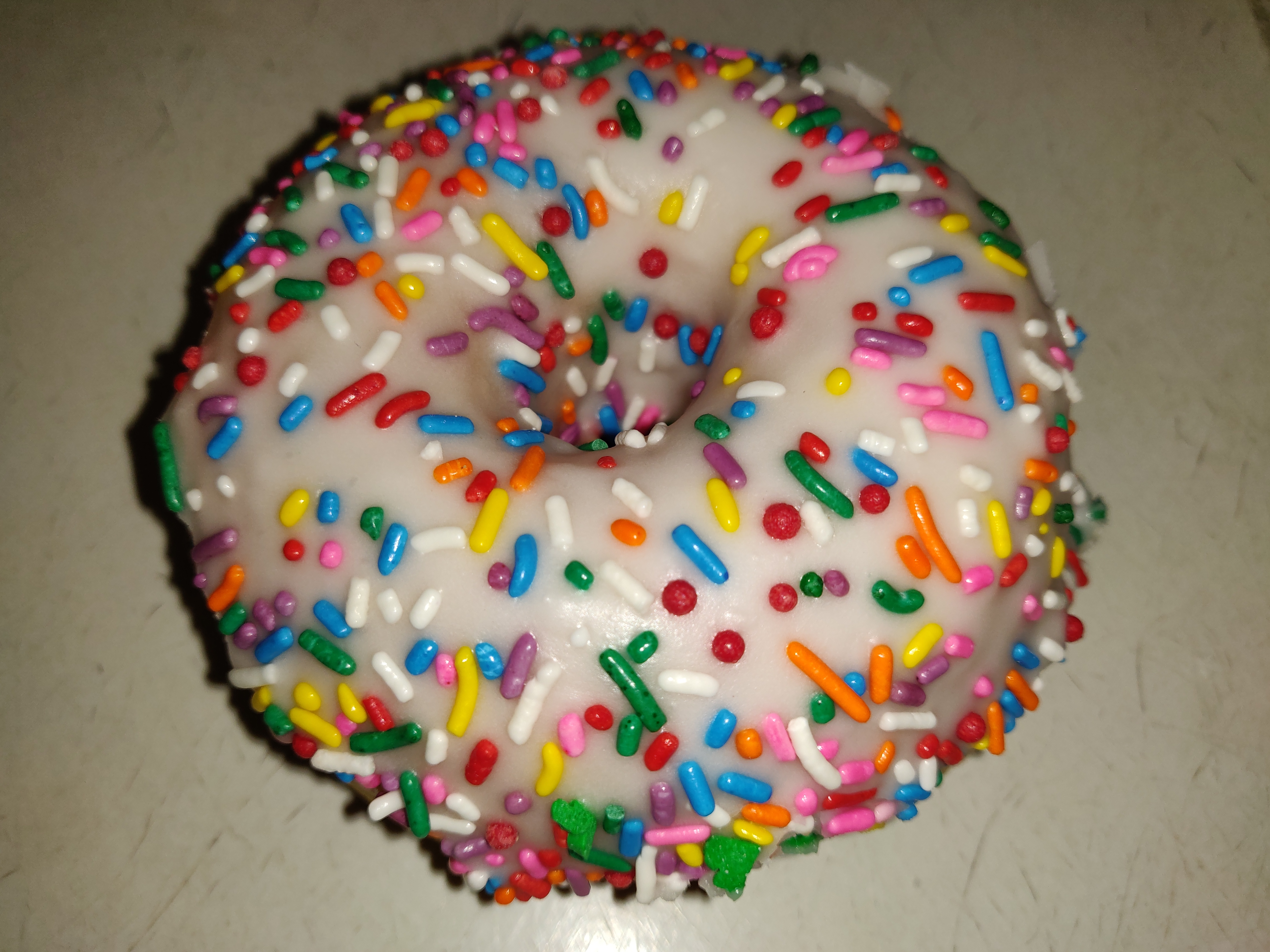 Order Rainbow Sprinkle Vanilla Glazed Donut food online from Donut Club store, San Dimas on bringmethat.com