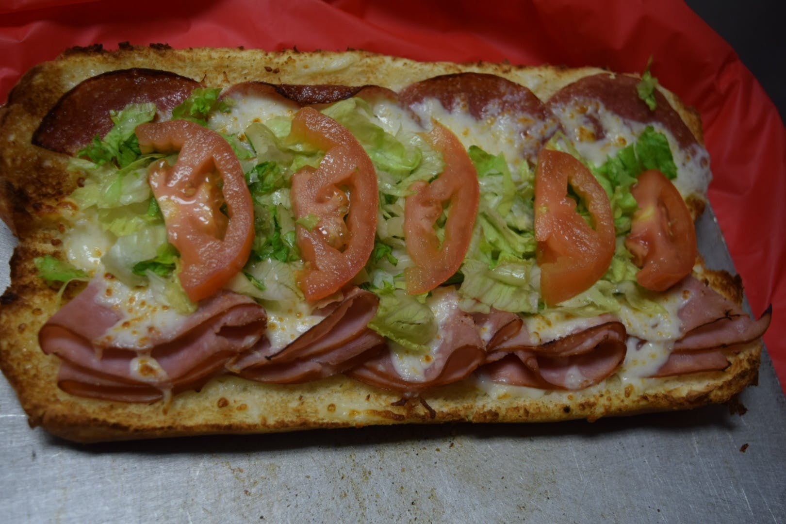 Order Italian Sub - Half food online from Pizza Parlor store, Pearland on bringmethat.com