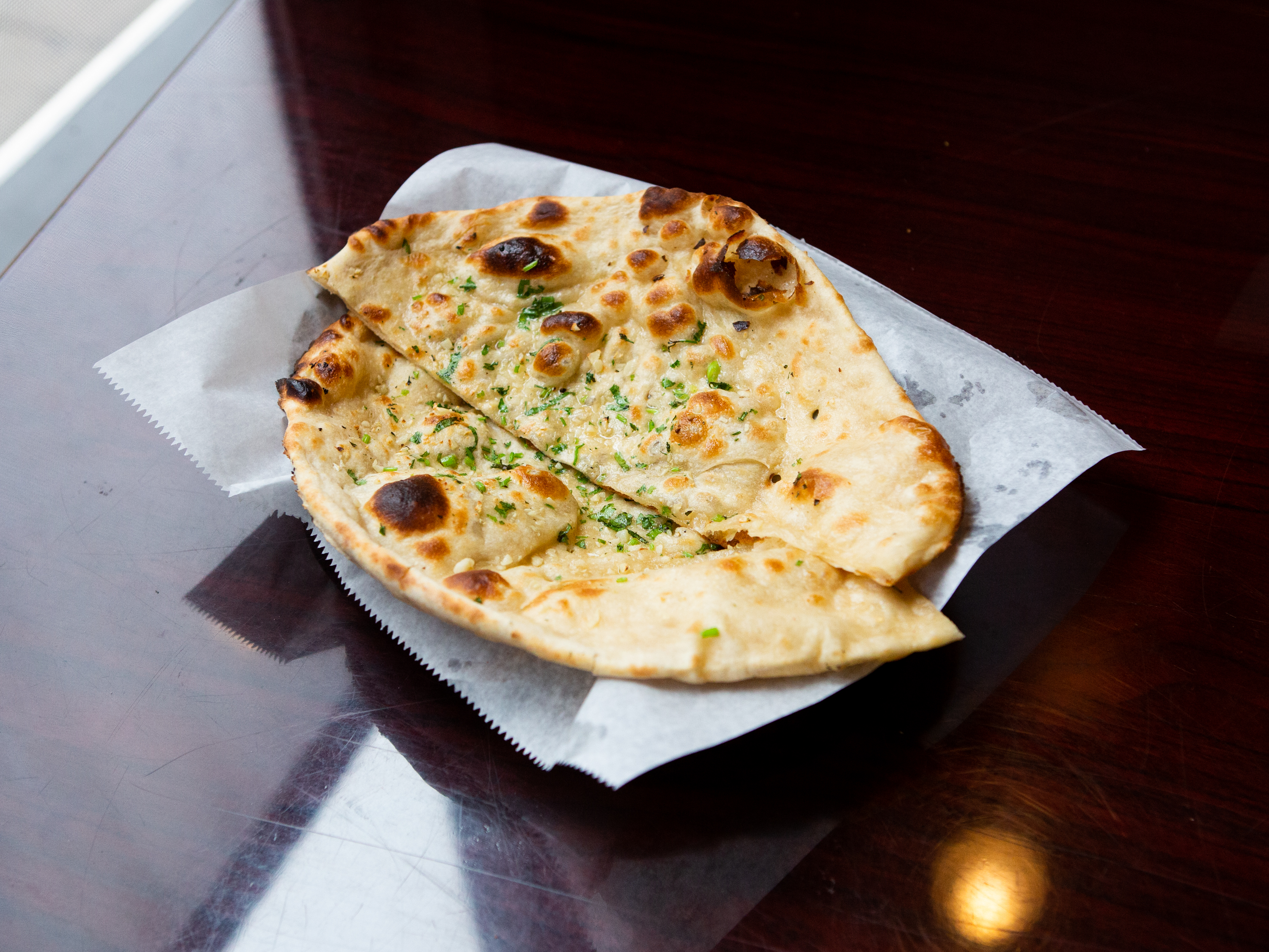 Order Garlic Naan food online from Bombay Indian Grill store, Morgantown on bringmethat.com