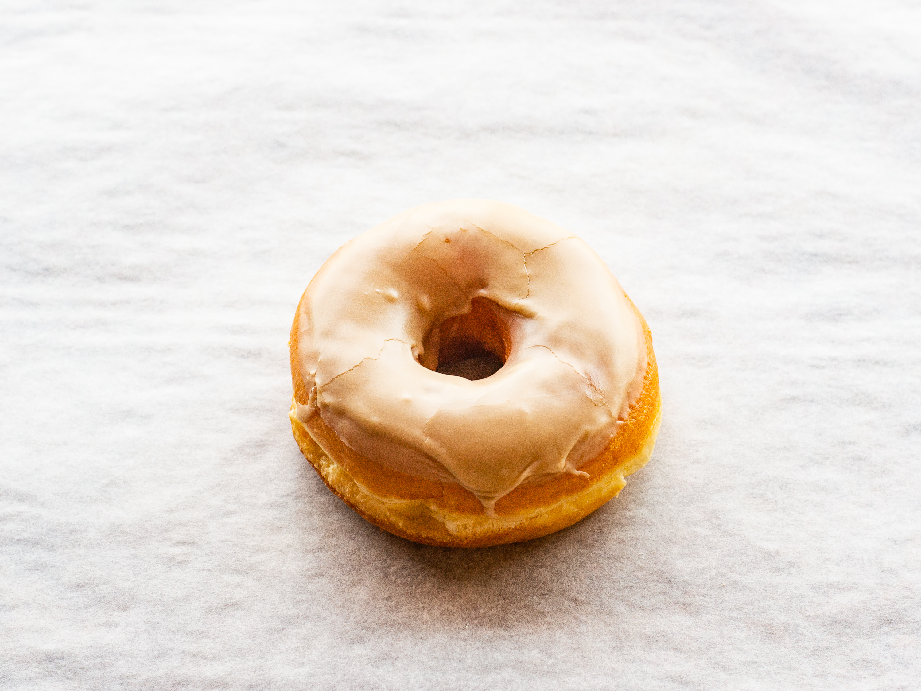 Order Maple Icing Raised Doughnut food online from Donuts To Go store, Reedley on bringmethat.com