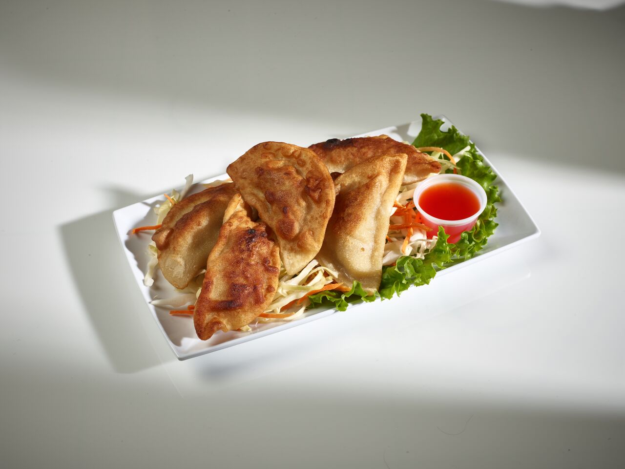 Order Pan Fried Pork Dumplings  food online from United Chinese Restaurant store, Broomfield on bringmethat.com