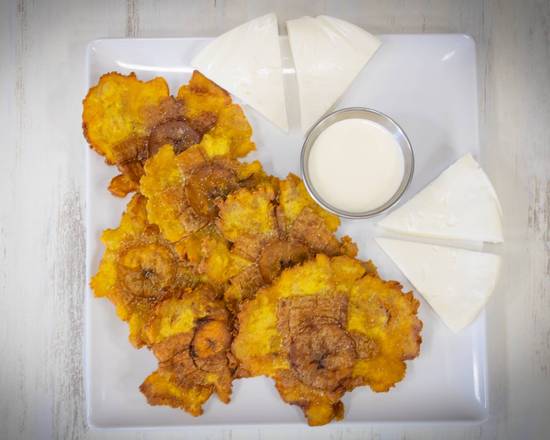 Order GREEN PLANTAIN WITH CHEESE AND SOUR CREAM/ TOSTONES CON NATA Y QUESO food online from Mordisko & Salsa store, Carrollton on bringmethat.com