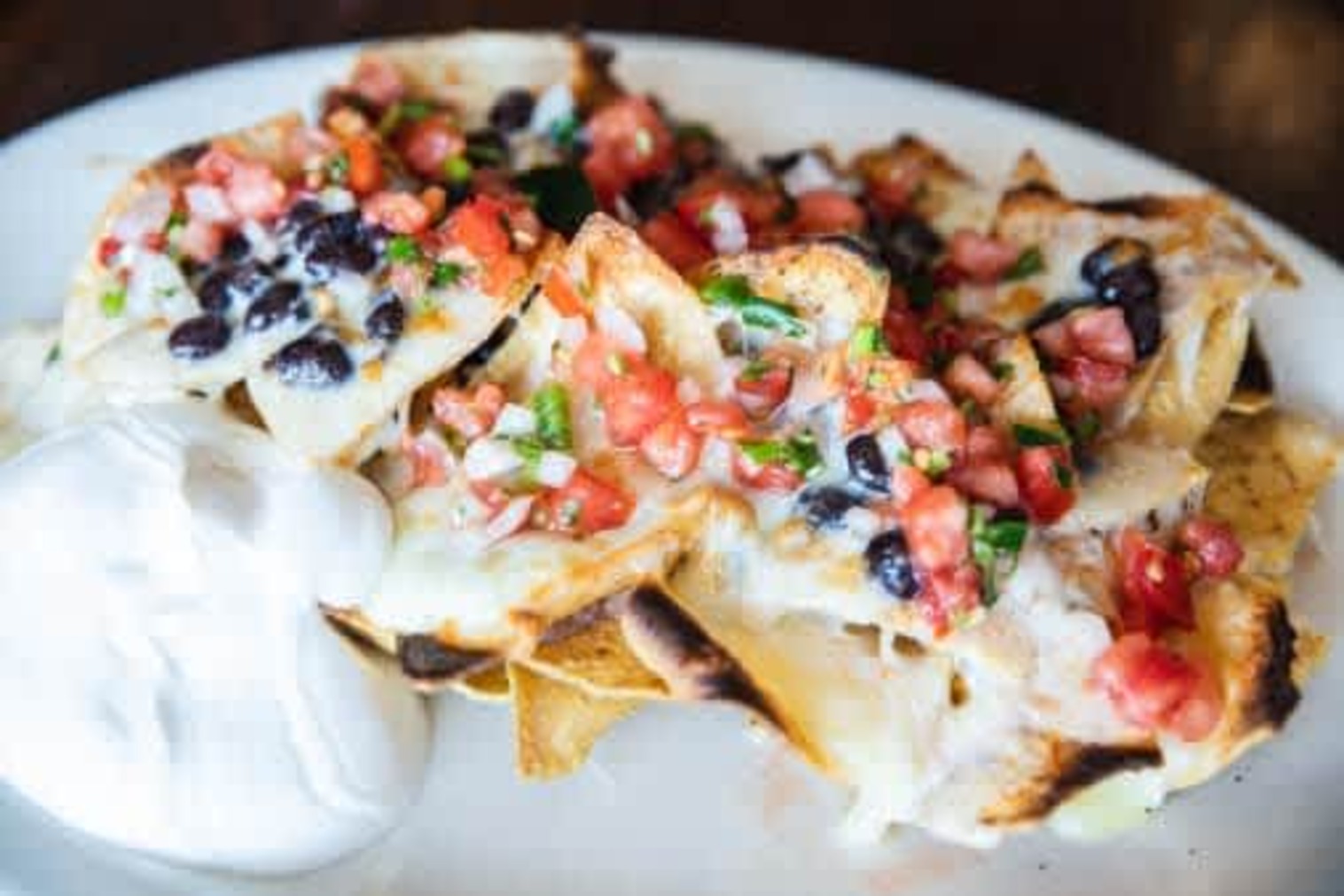 Order Nachos - Large, good for 2 to 4 food online from La Veracruzana Mexican Restaurant store, Amherst on bringmethat.com