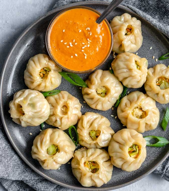 Order Steamed Veg Momo  ( comes with Spicy sauce dip outside)   food online from Empyrean Indian Kitchen store, Hoboken on bringmethat.com