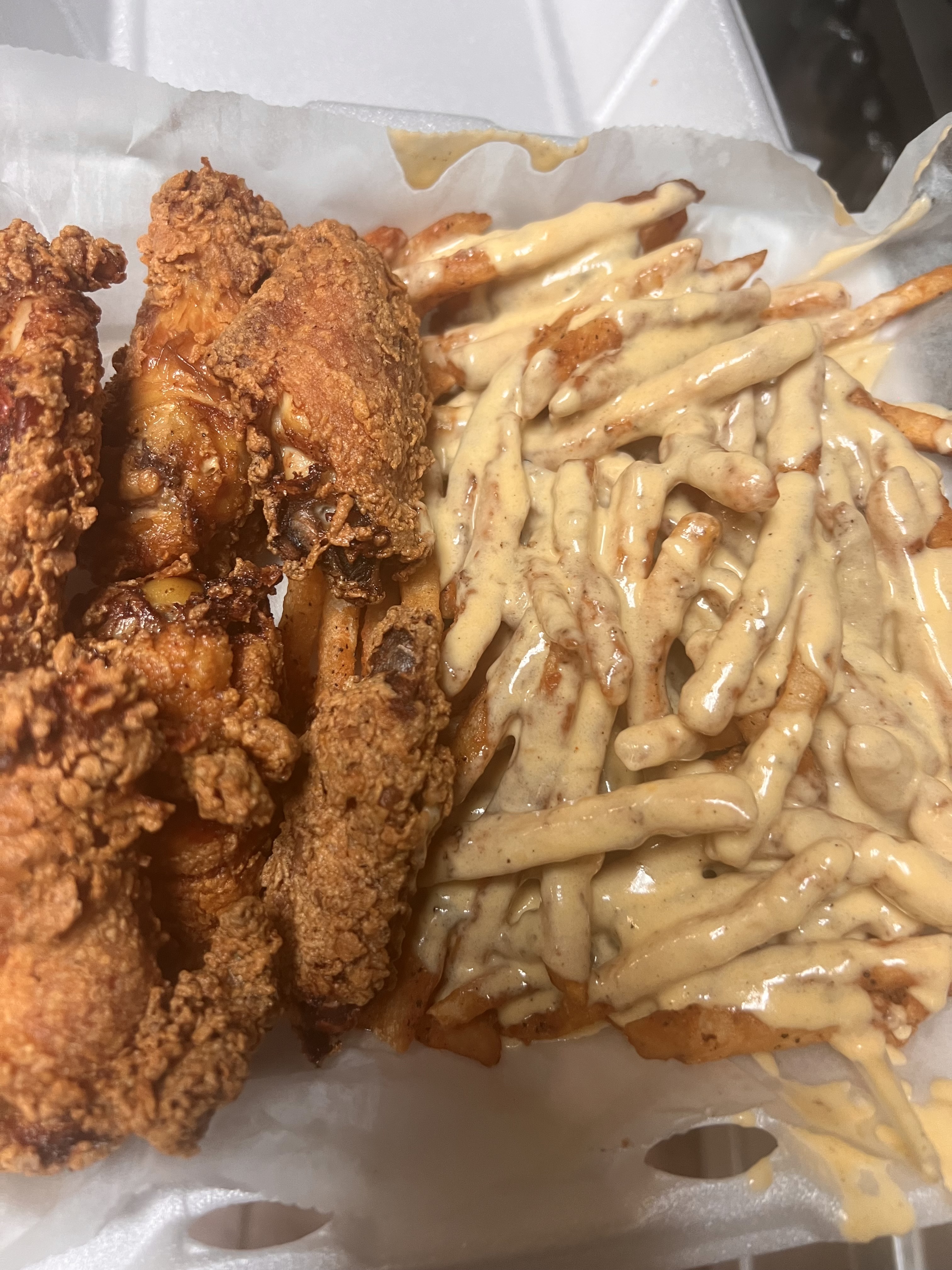 Order Fried chicken wings & Cajun fries with homemade cheese  food online from Norah'S Irie Jamaican Restaurant store, Long Branch on bringmethat.com