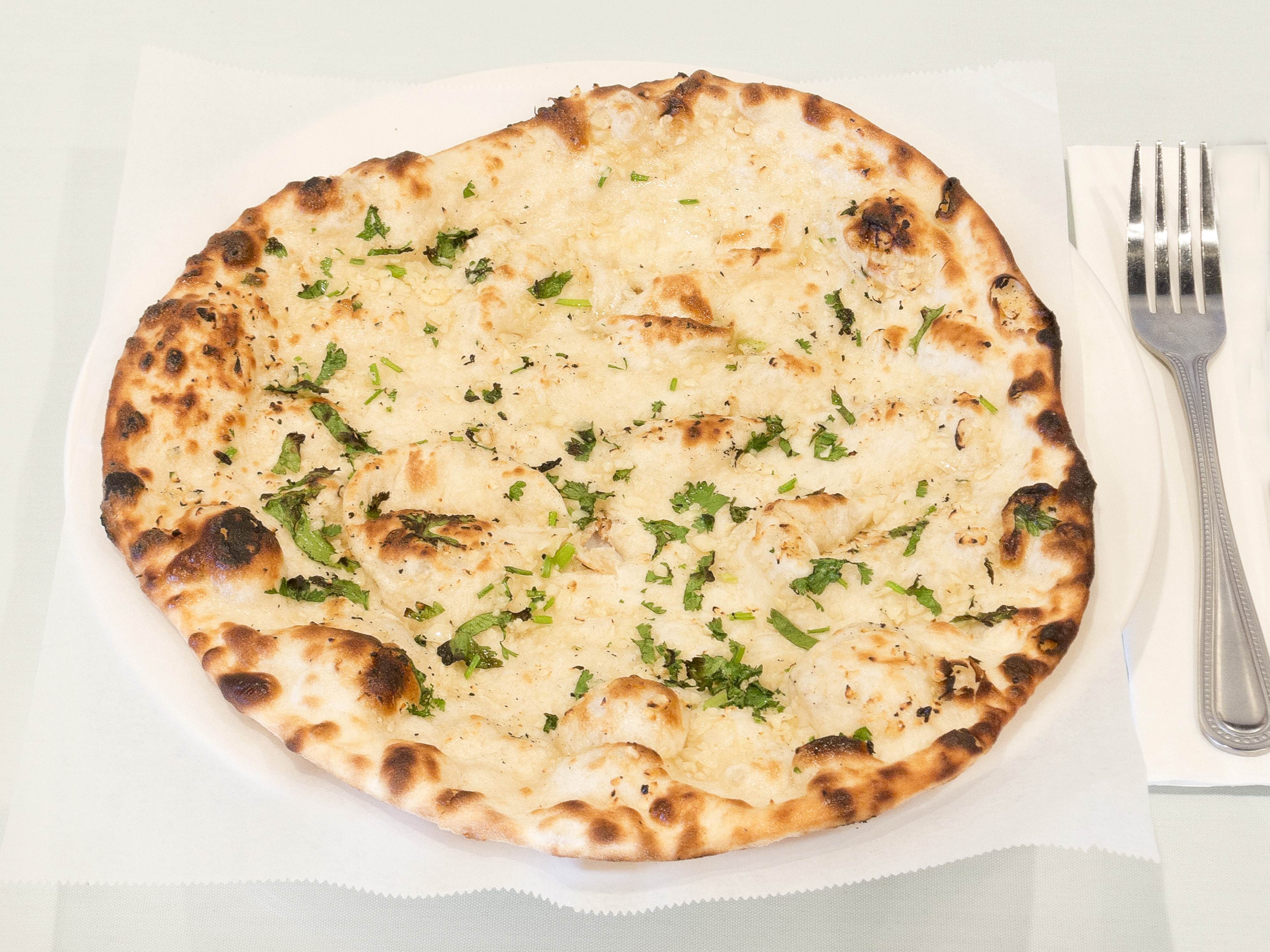 Order Garlic Naan food online from Wild Mirchi Indian Grill store, Plano on bringmethat.com