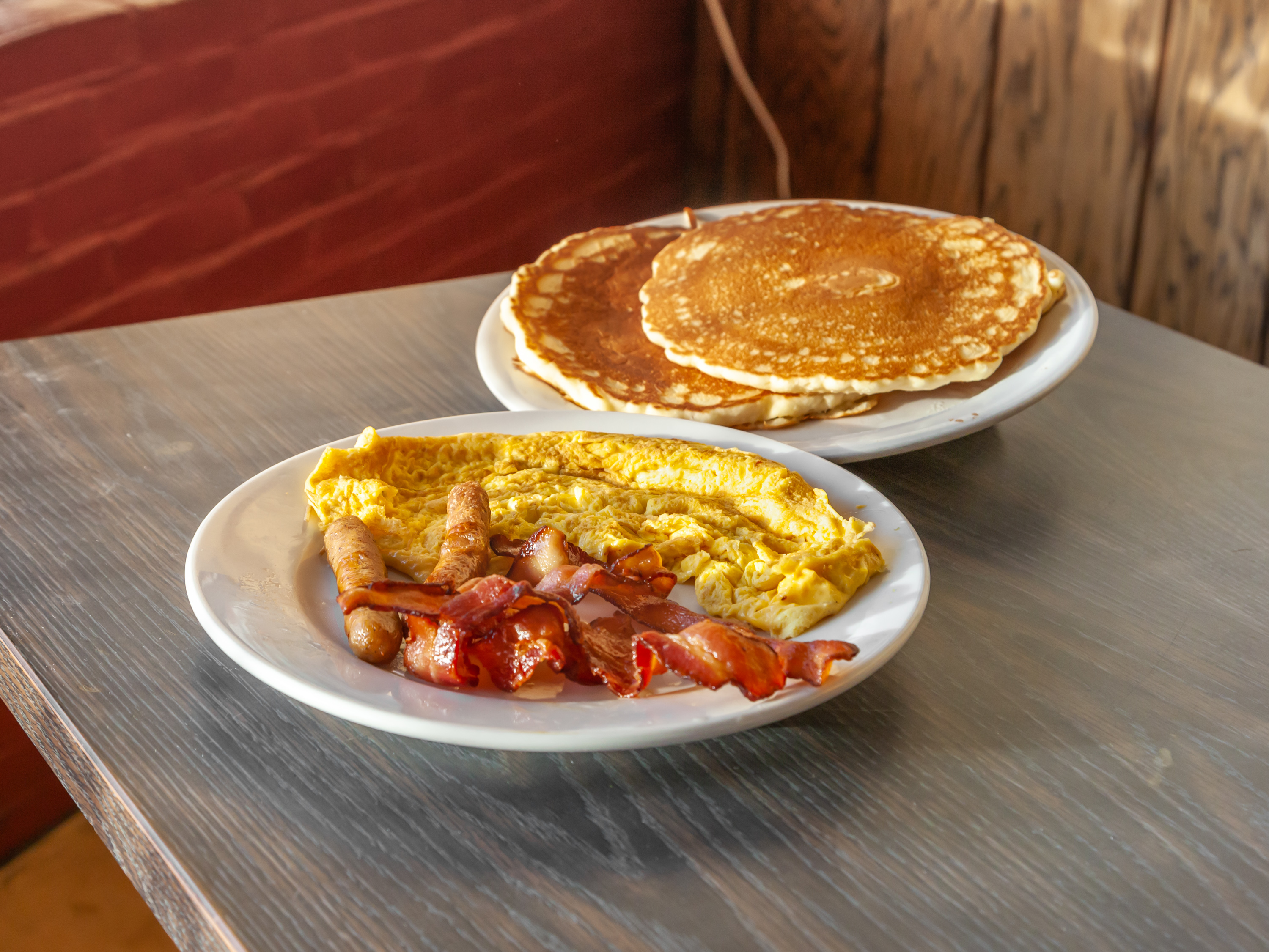 Order #22. Two Pancakes with 2 Eggs, Bacon and Sausage food online from Brothers deli restaurant store, Mattapan on bringmethat.com