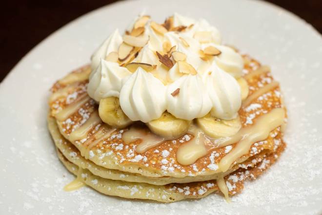 Order Banana Cream Pancakes food online from Village Inn store, Fremont on bringmethat.com