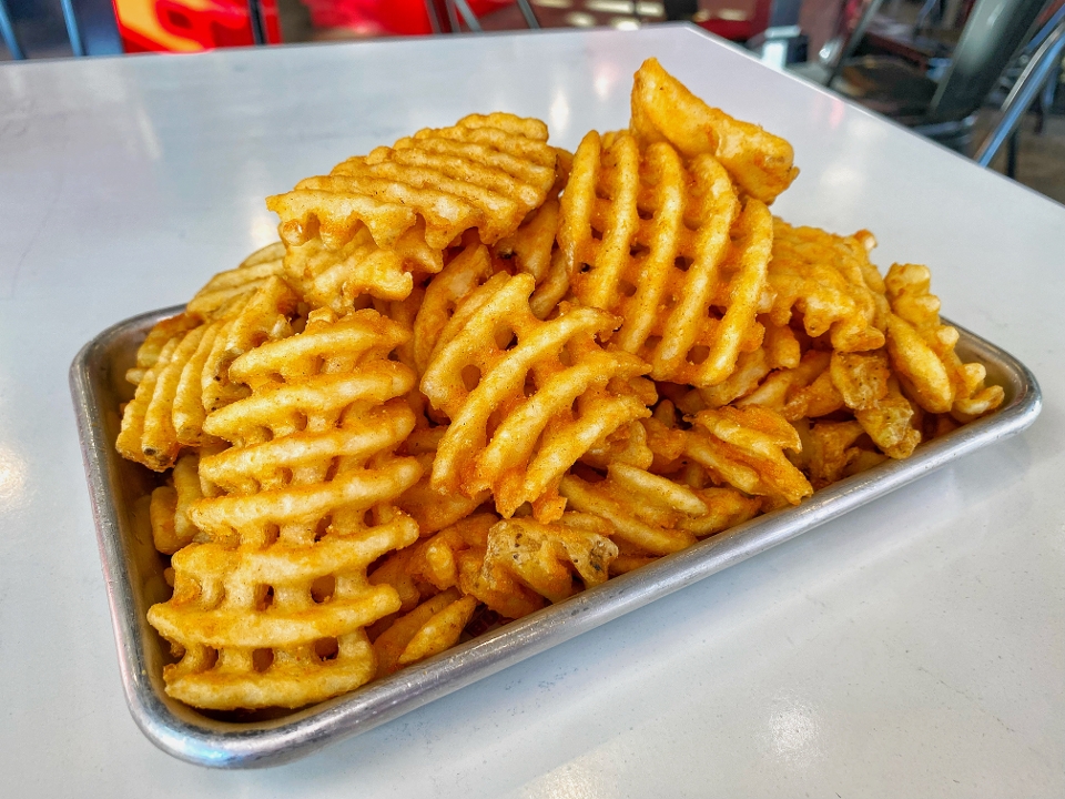 Order Large Seasoned Waffle Fries food online from The Waffle Bus store, Houston on bringmethat.com