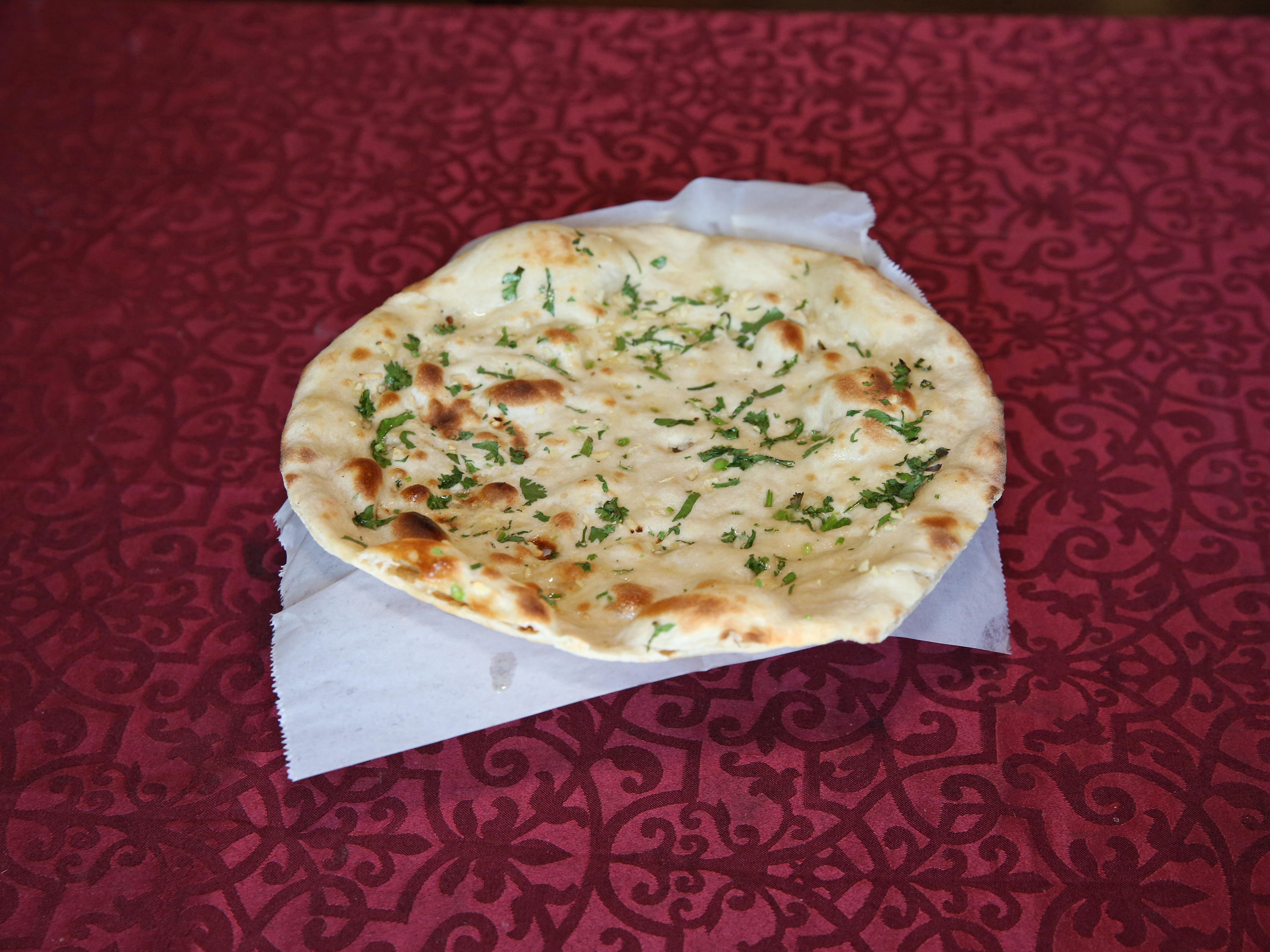 Order Garlic Naan food online from Cafe India store, Cedar Park on bringmethat.com