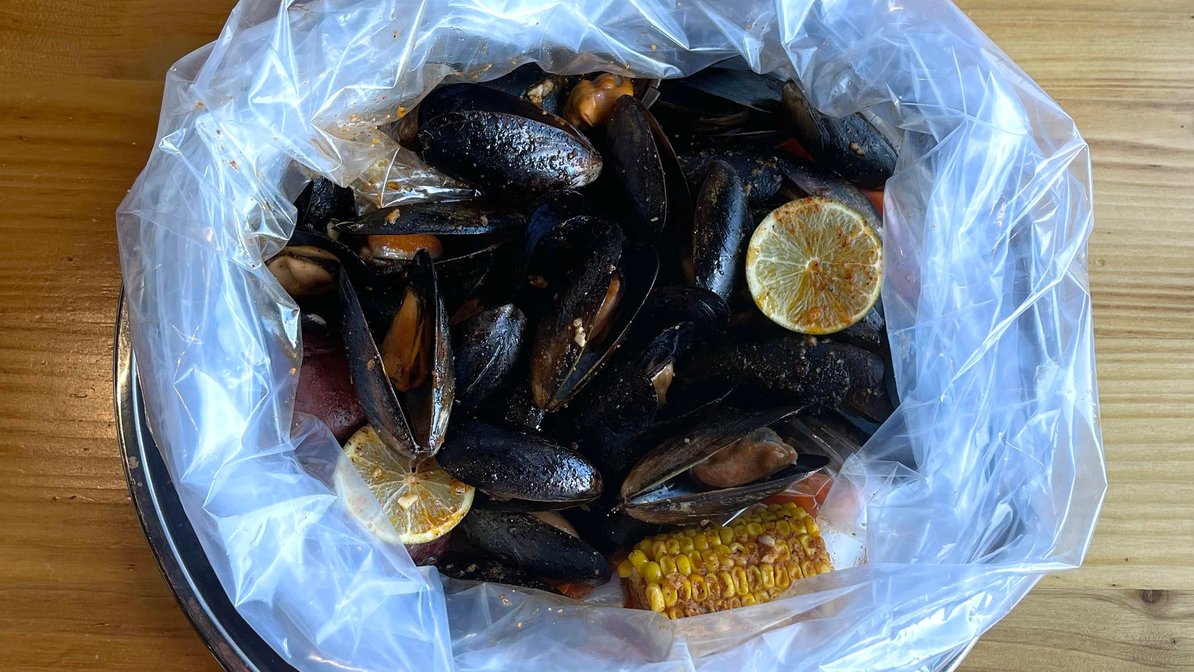 Order 1 Lb Black Mussel food online from The Juicy Seafood store, Sandy Springs on bringmethat.com