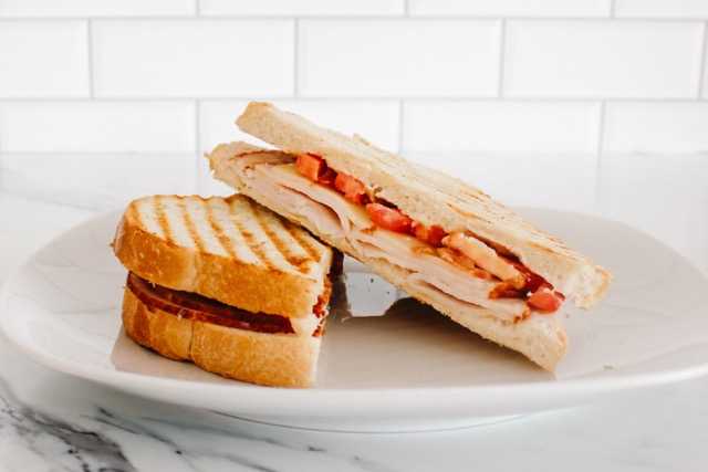 Order Turkey Breast Panini food online from Postres Cafe store, Bellflower on bringmethat.com